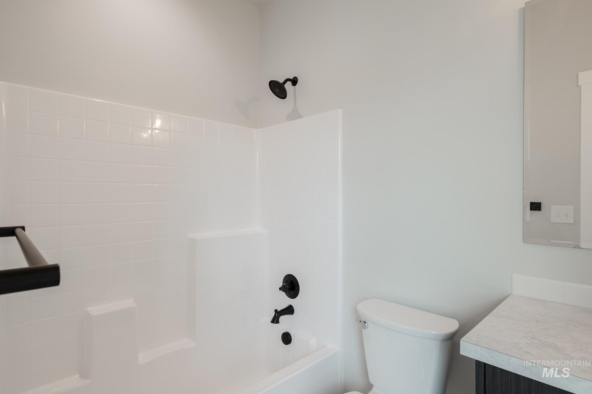 Bathroom with vanity and bathing tub / shower combination
