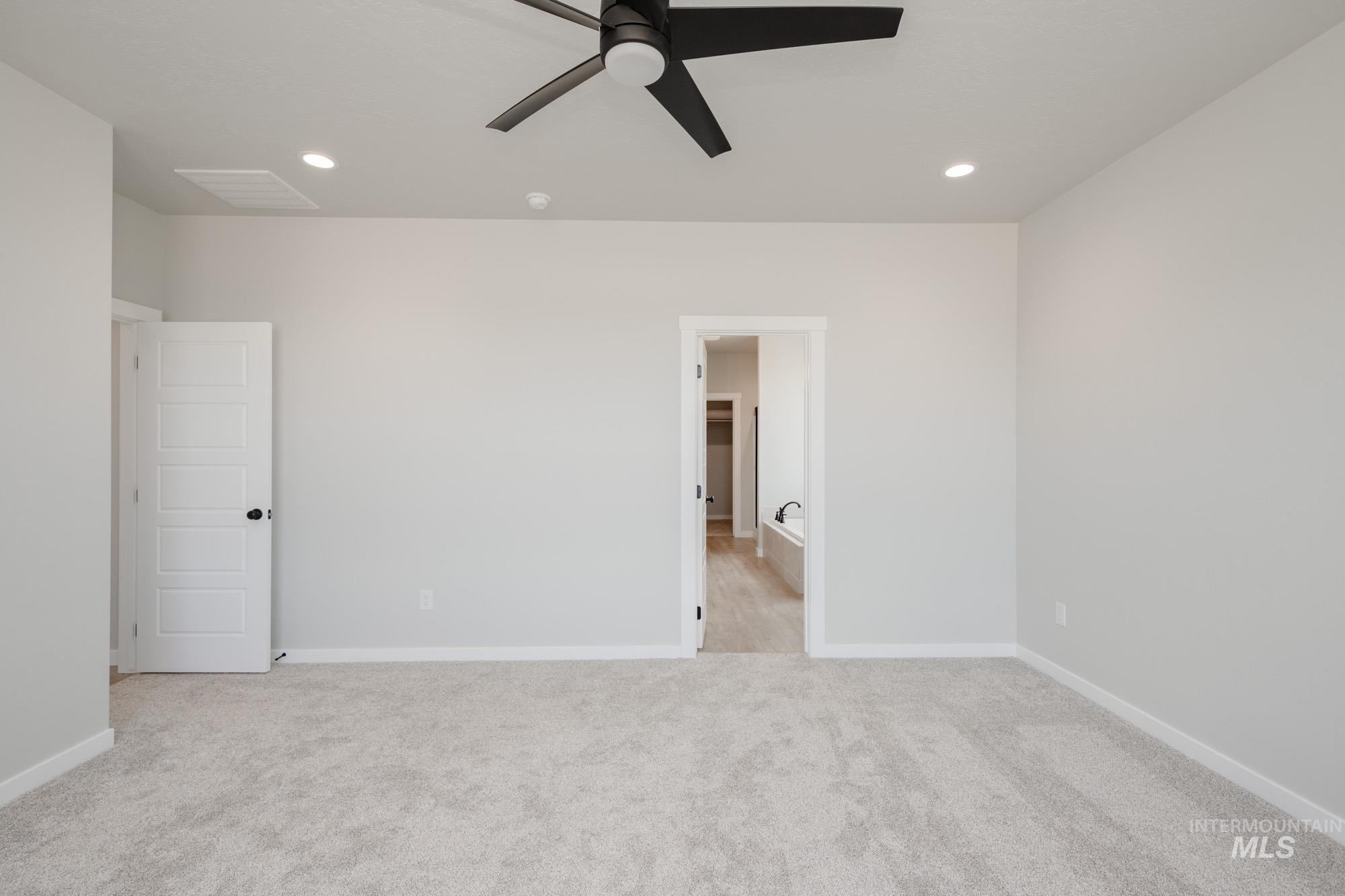 Unfurnished bedroom featuring light carpet, recessed lighting, and ceiling fan