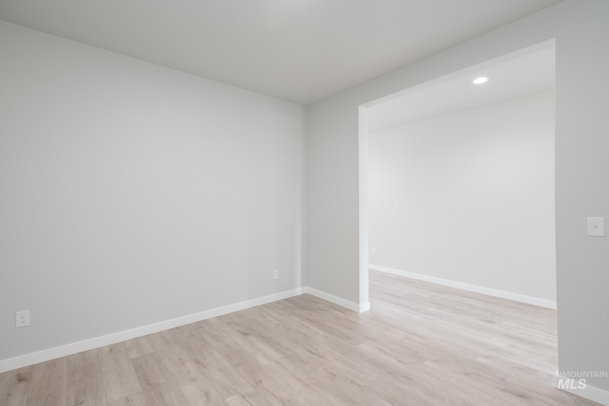 Spare room featuring light wood-style flooring and recessed lighting