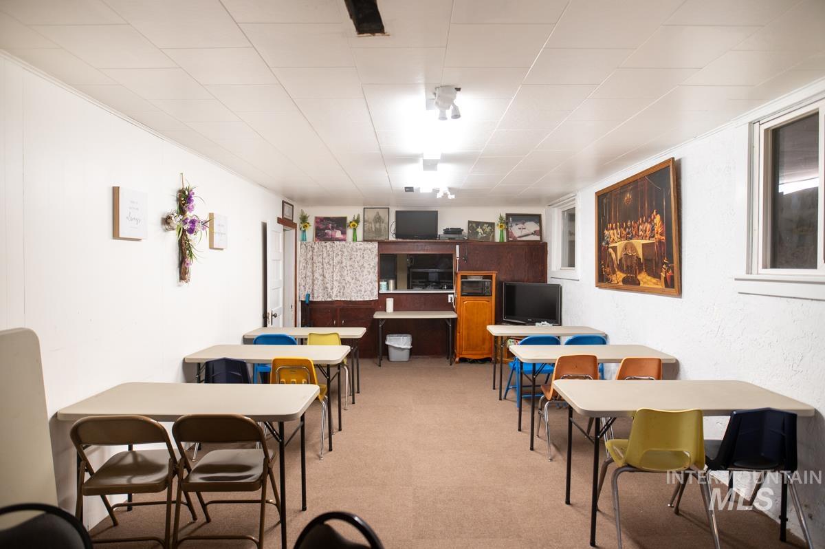Dining room with light carpet and a textured wall