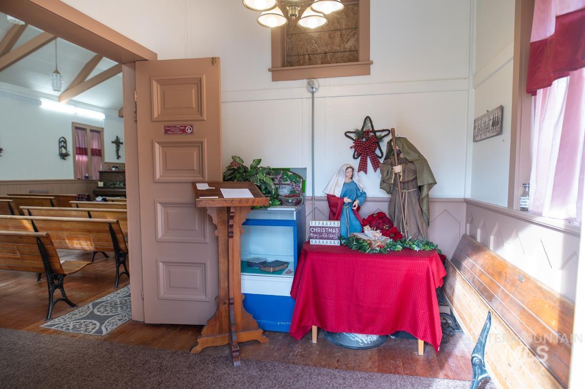 Dining room with wood finished floors, a decorative wall, and a wainscoted wall