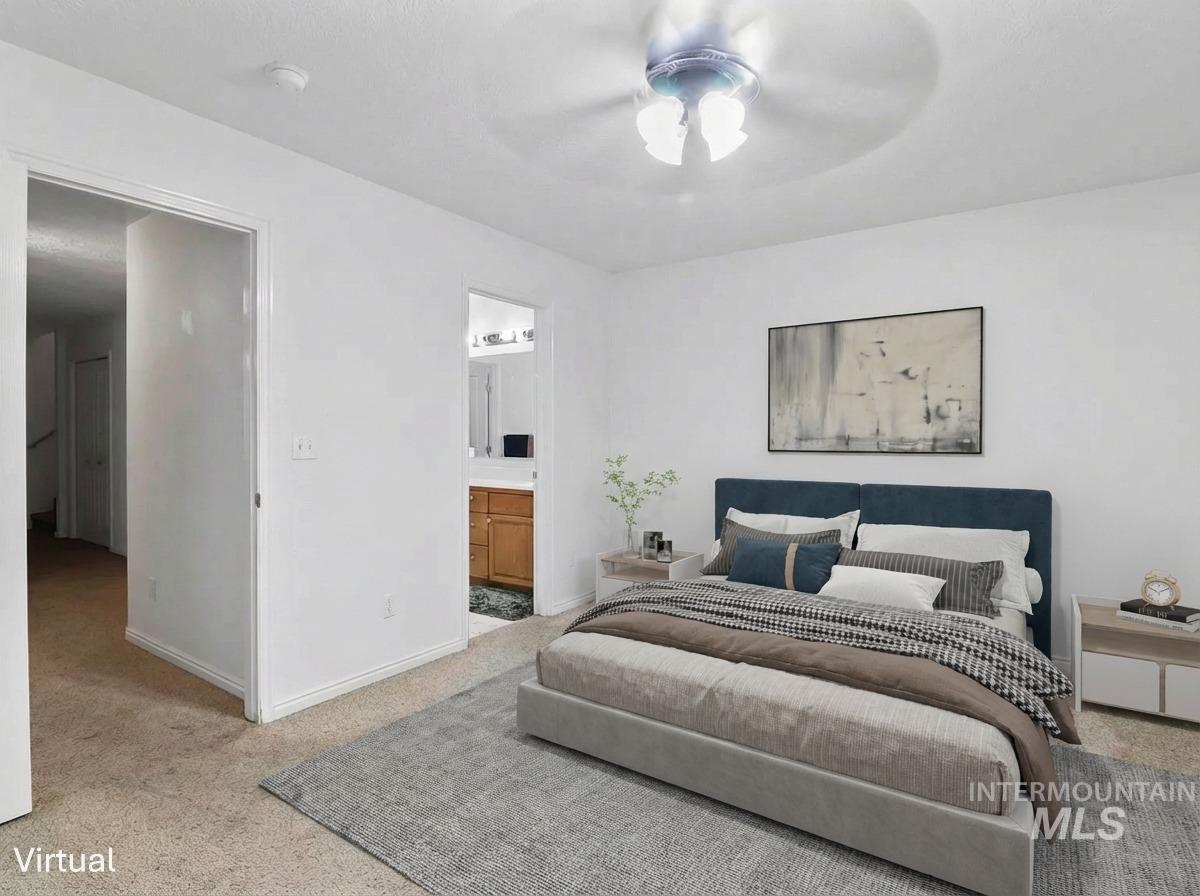 Bedroom featuring carpet flooring, ceiling fan, and ensuite bath