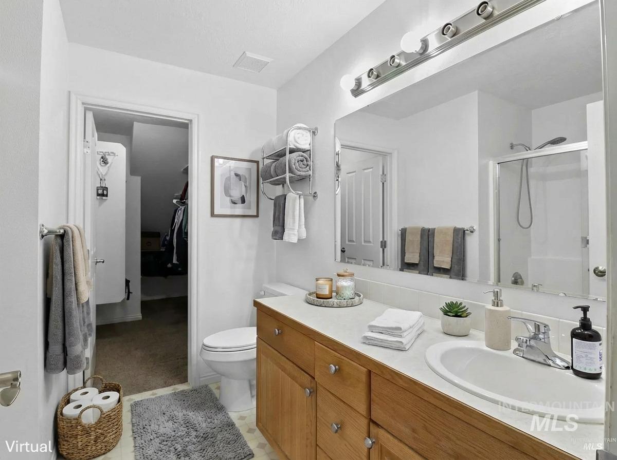 Bathroom featuring vanity and a stall shower