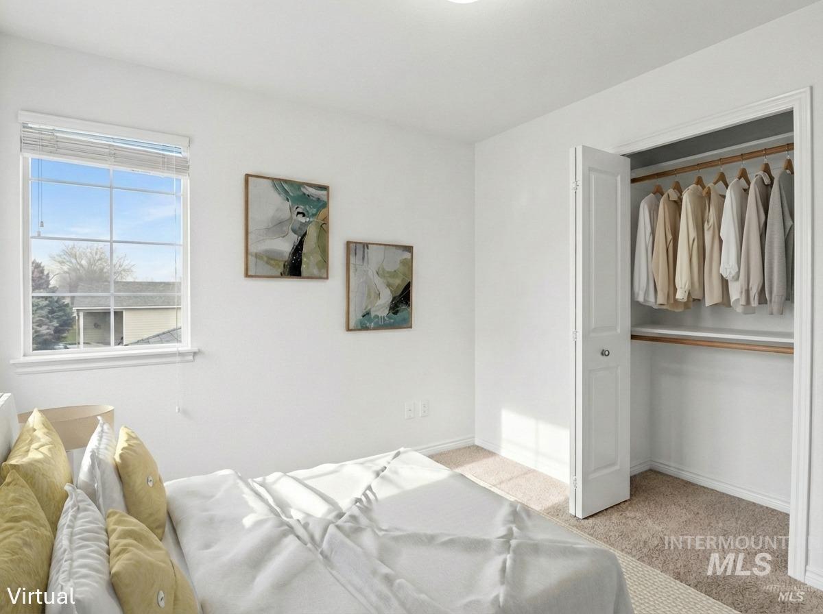 Bedroom with light carpet and a closet