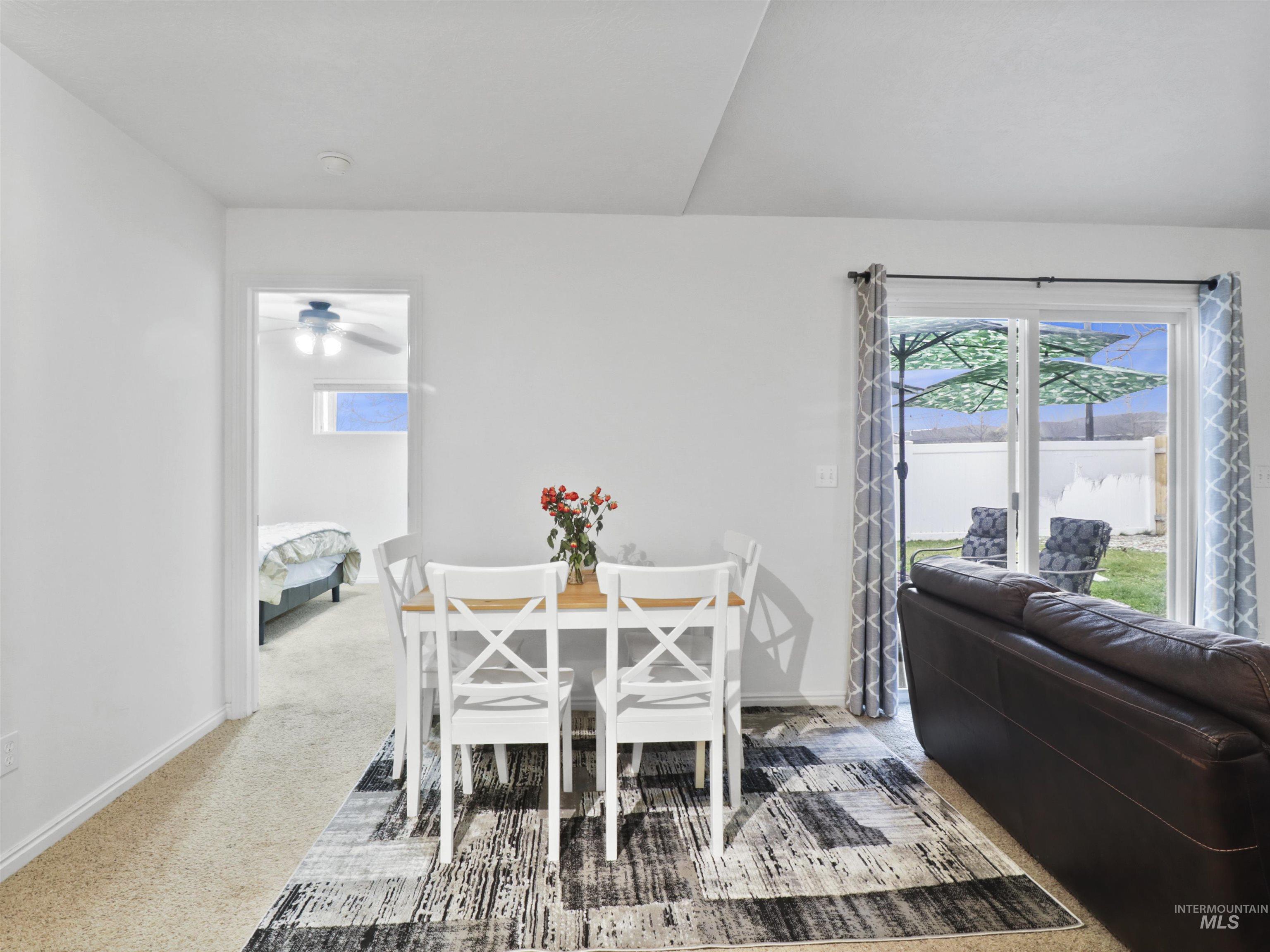 Dining space with carpet flooring and baseboards