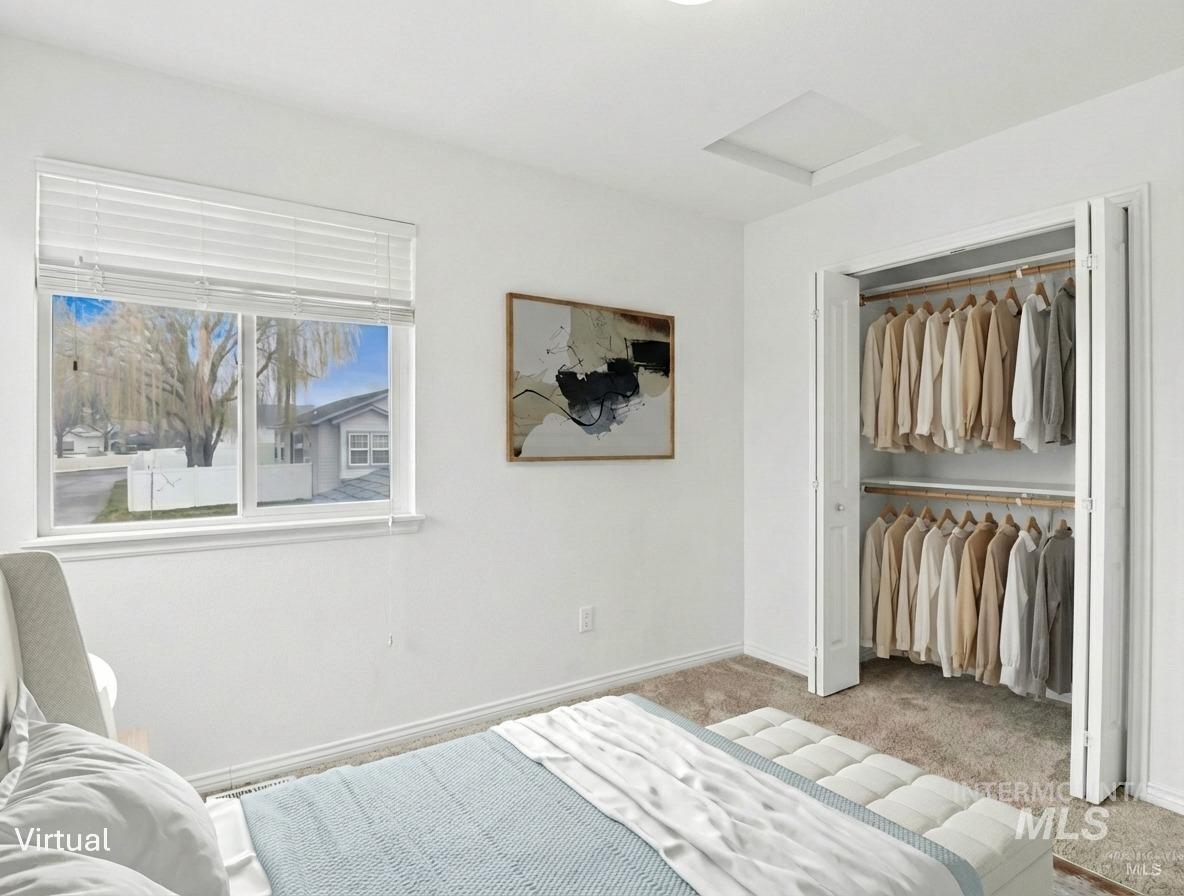 Bedroom featuring carpet and a closet