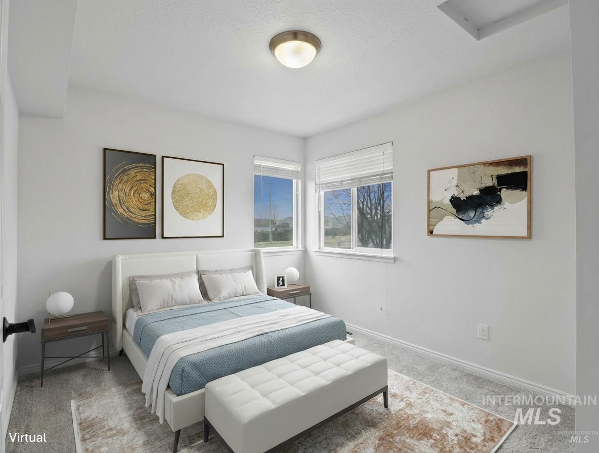 Carpeted bedroom featuring baseboards