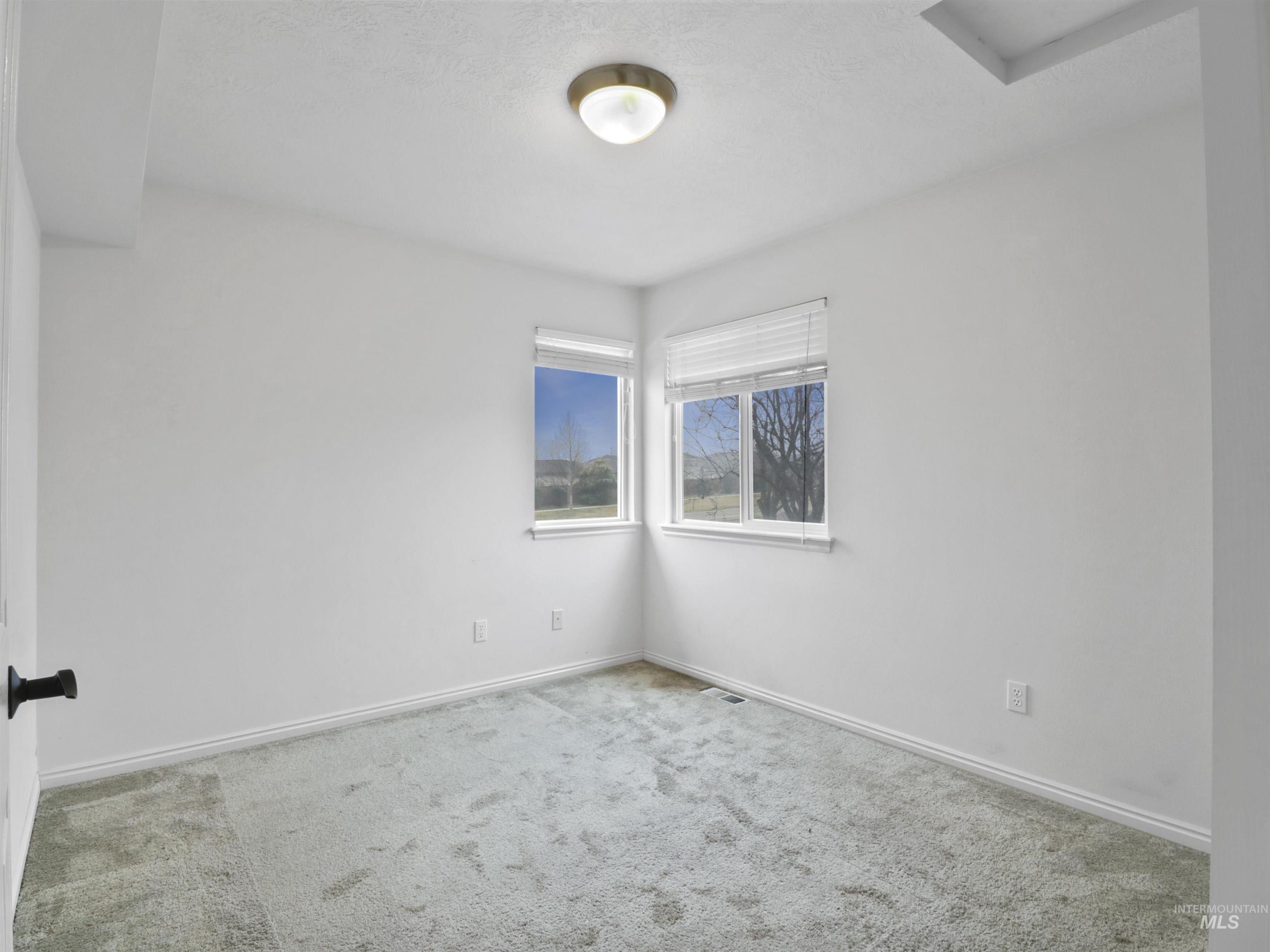 Unfurnished room featuring carpet and baseboards