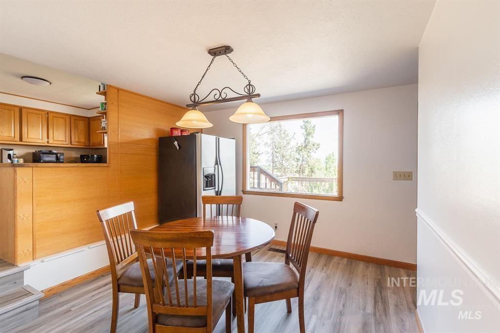 Dining room featuring light wood-type flooring and baseboards
