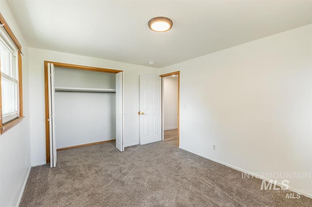 Unfurnished bedroom featuring carpet flooring and a closet
