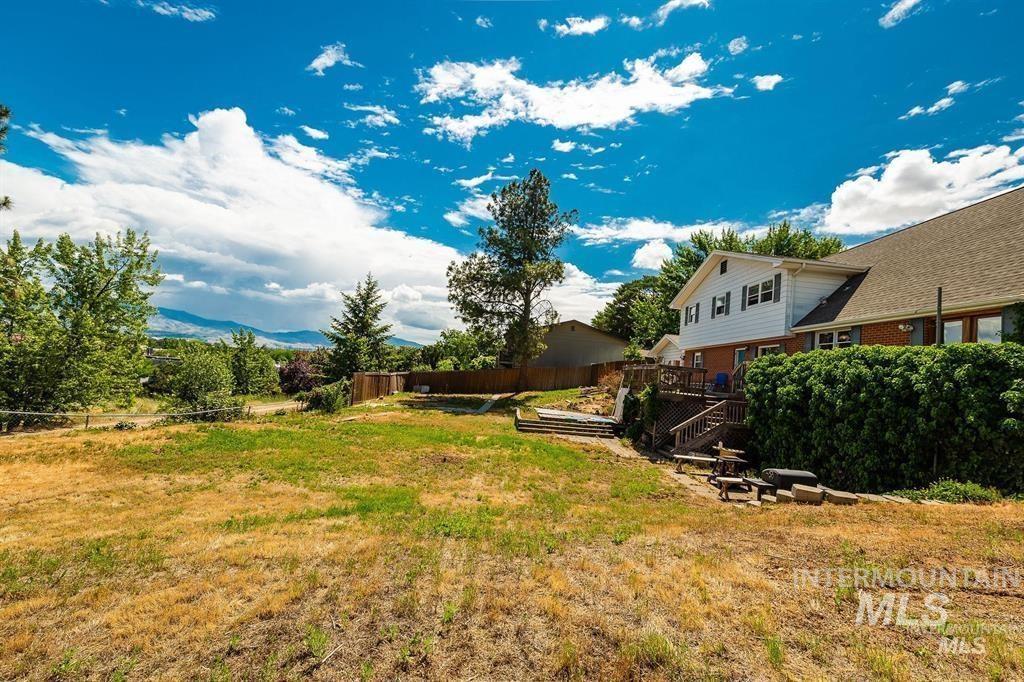 View of yard featuring a deck with mountain view