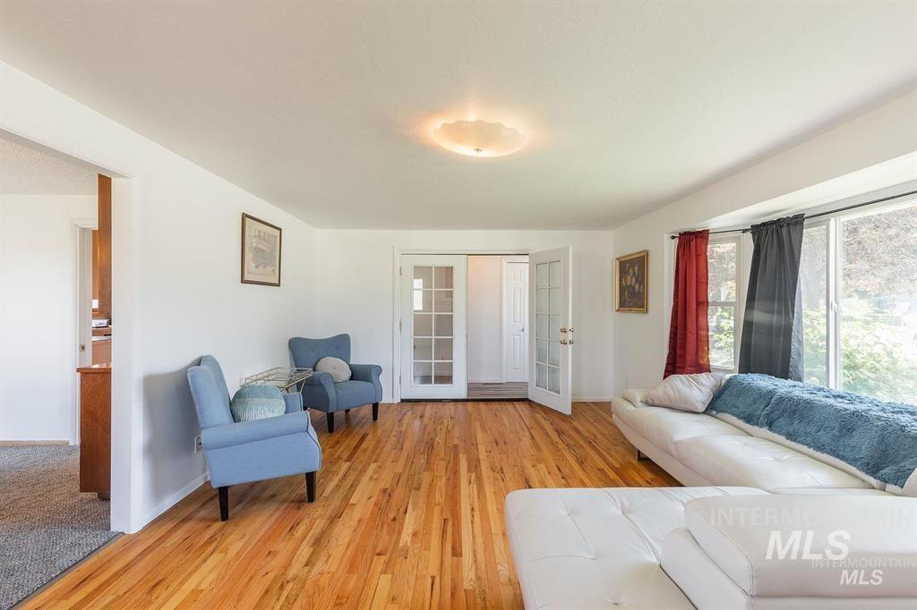 Living area with light wood finished floors and baseboards