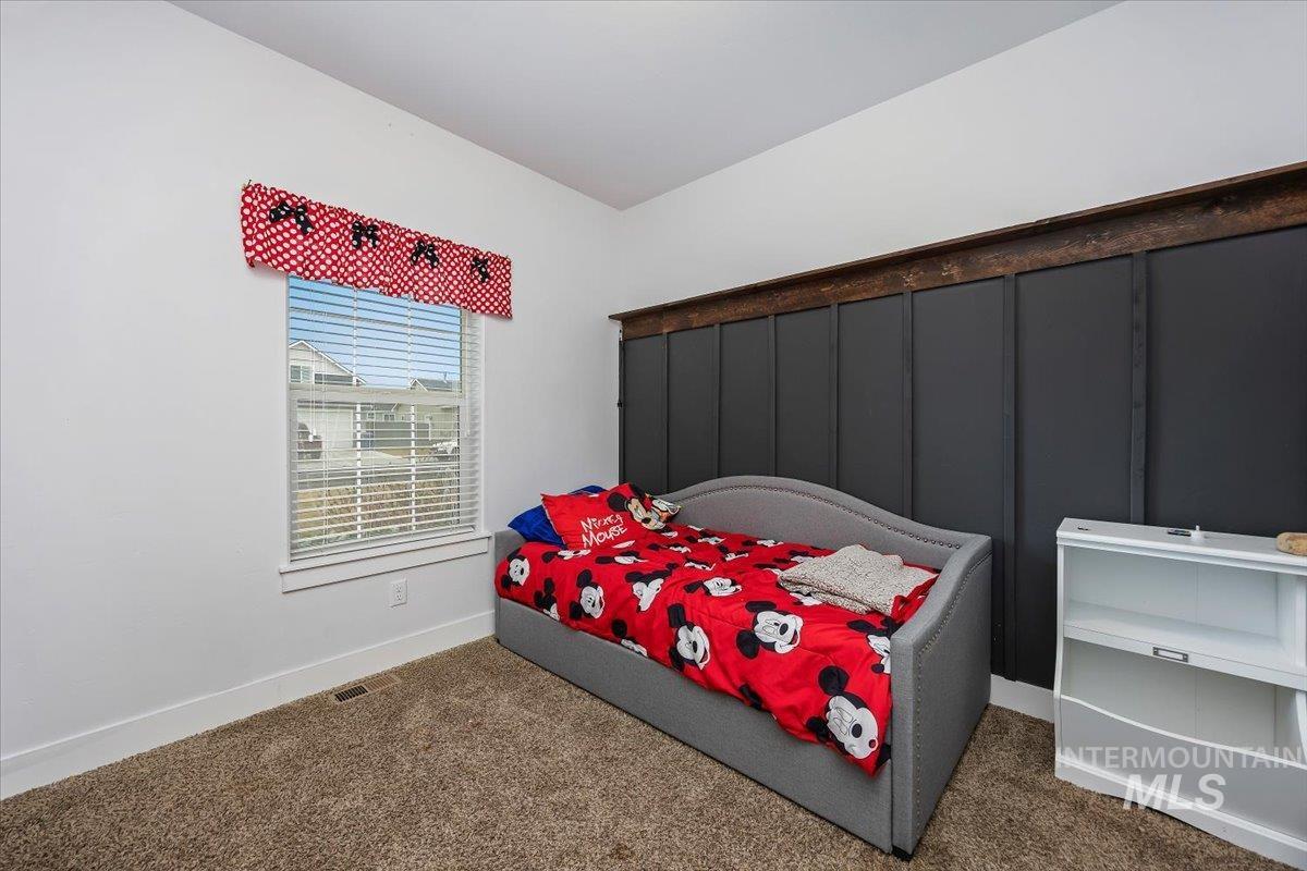 Carpeted bedroom featuring baseboards