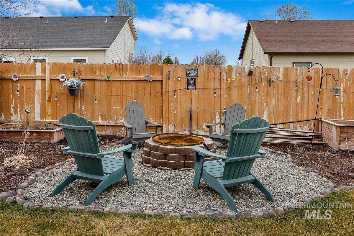 Fenced yard featuring a fire pit and a patio