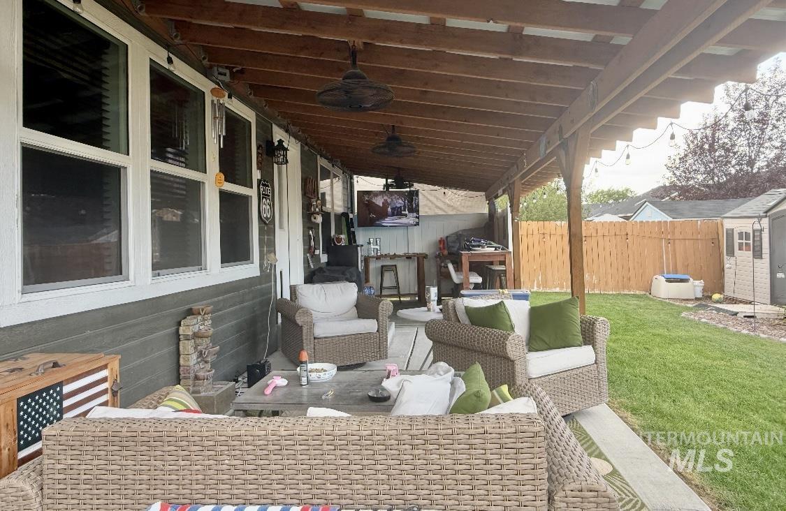 View of patio / terrace with an outdoor living space and ceiling fan