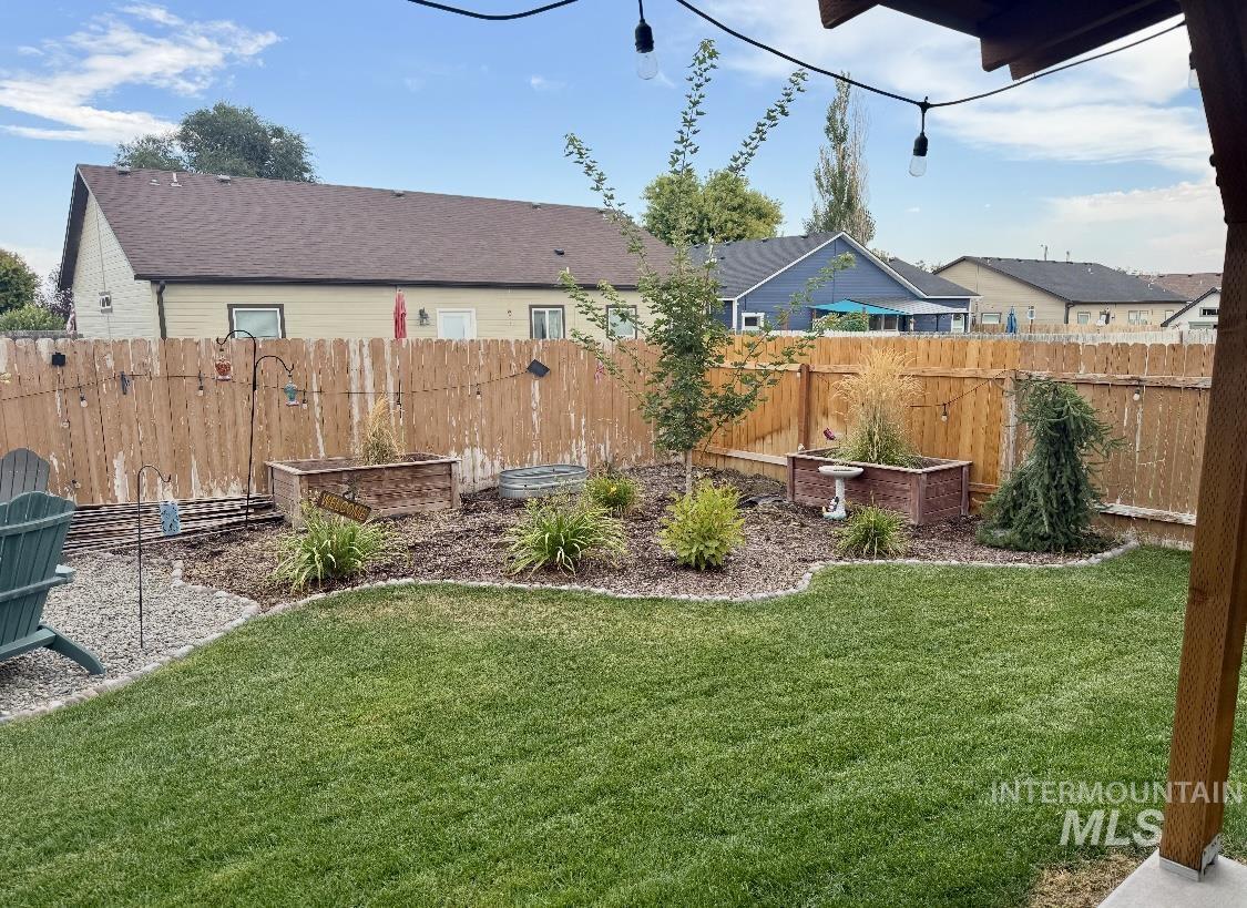Fenced backyard featuring a residential view