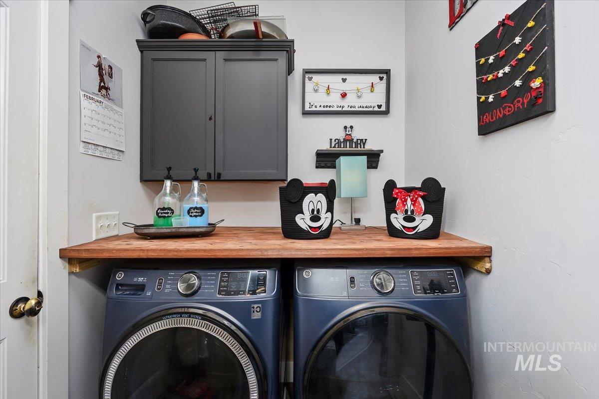 Laundry room featuring cabinet space and washer and dryer