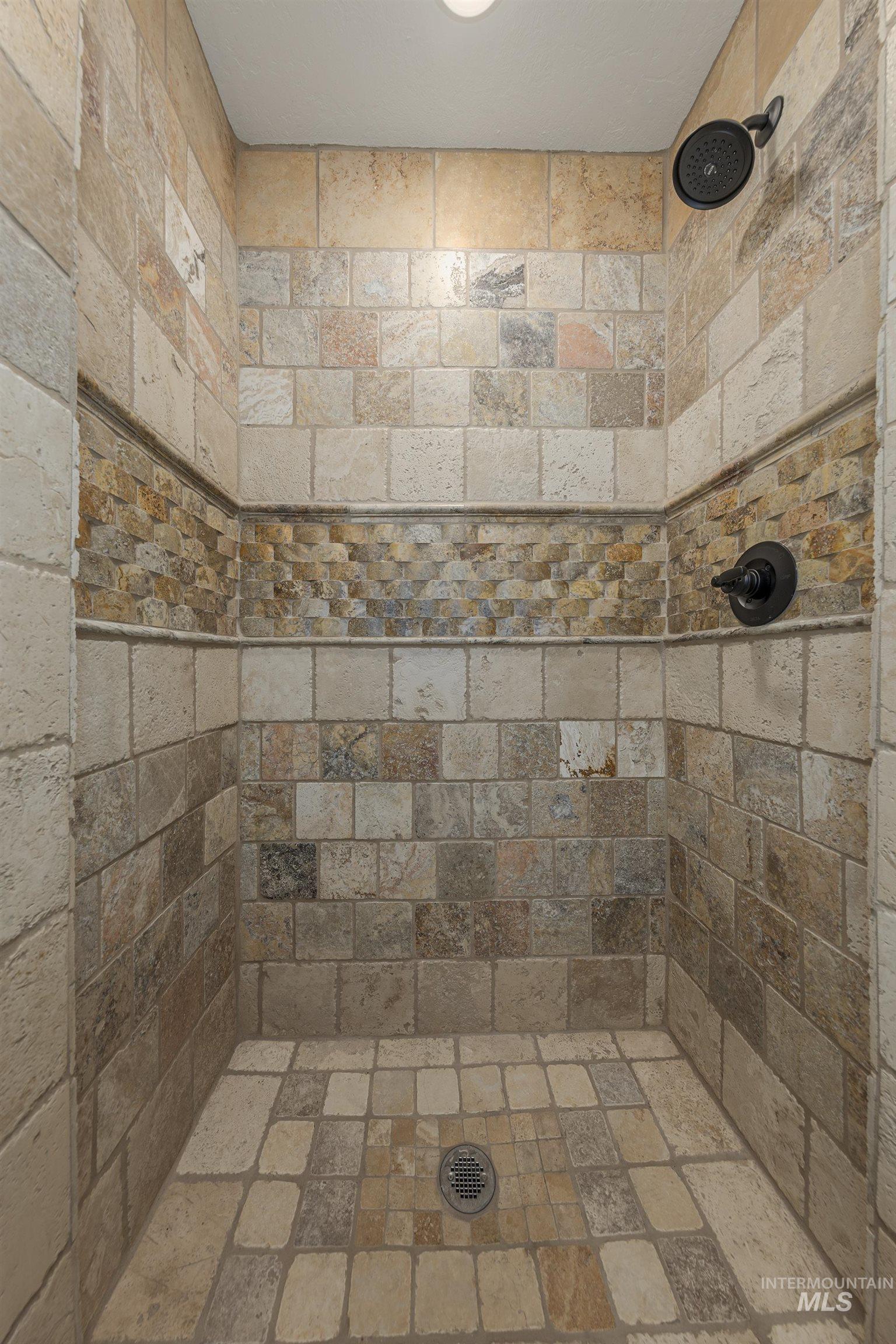 Bathroom featuring a tile shower