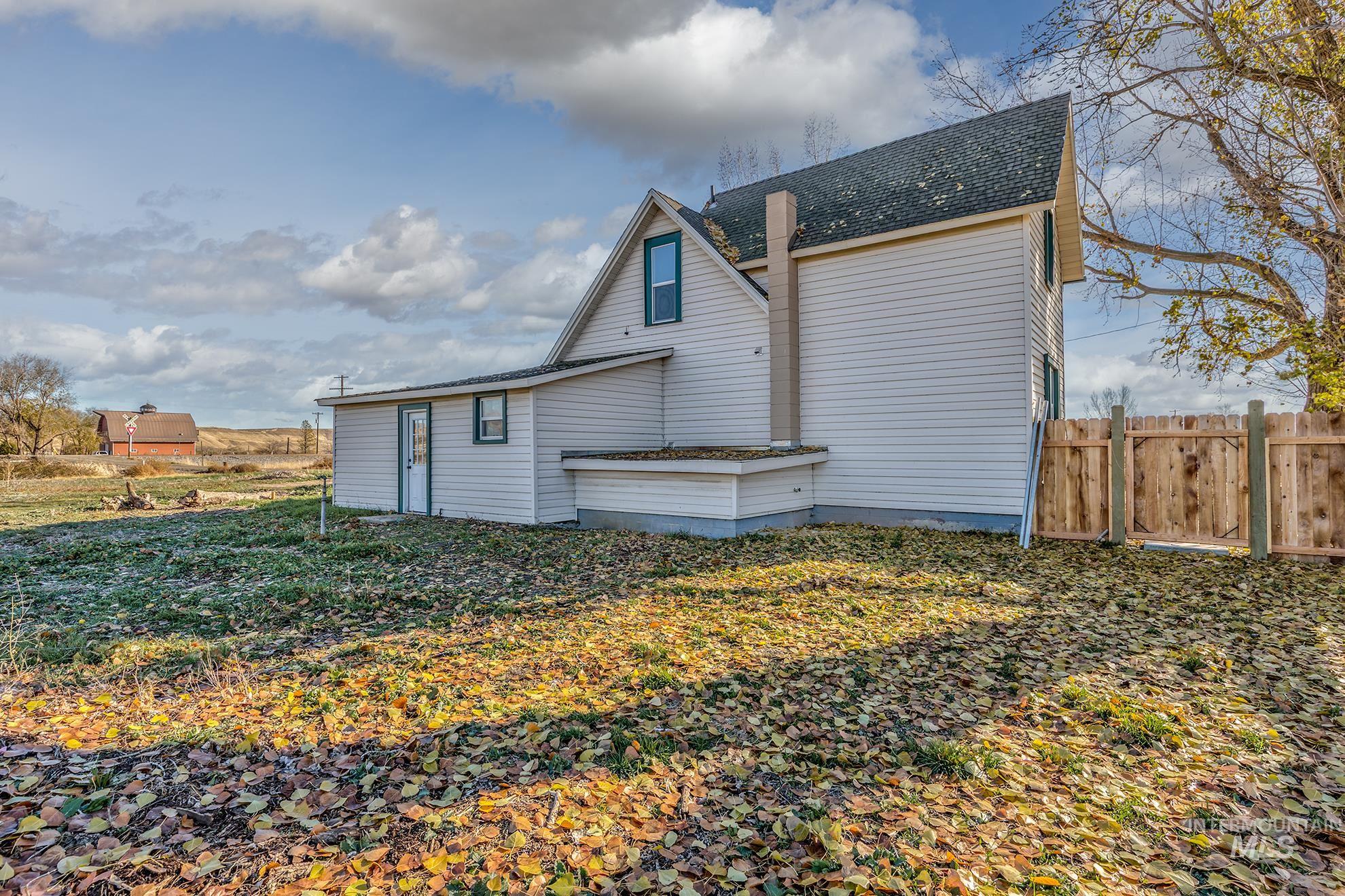 Rear view of property with roof with shingles