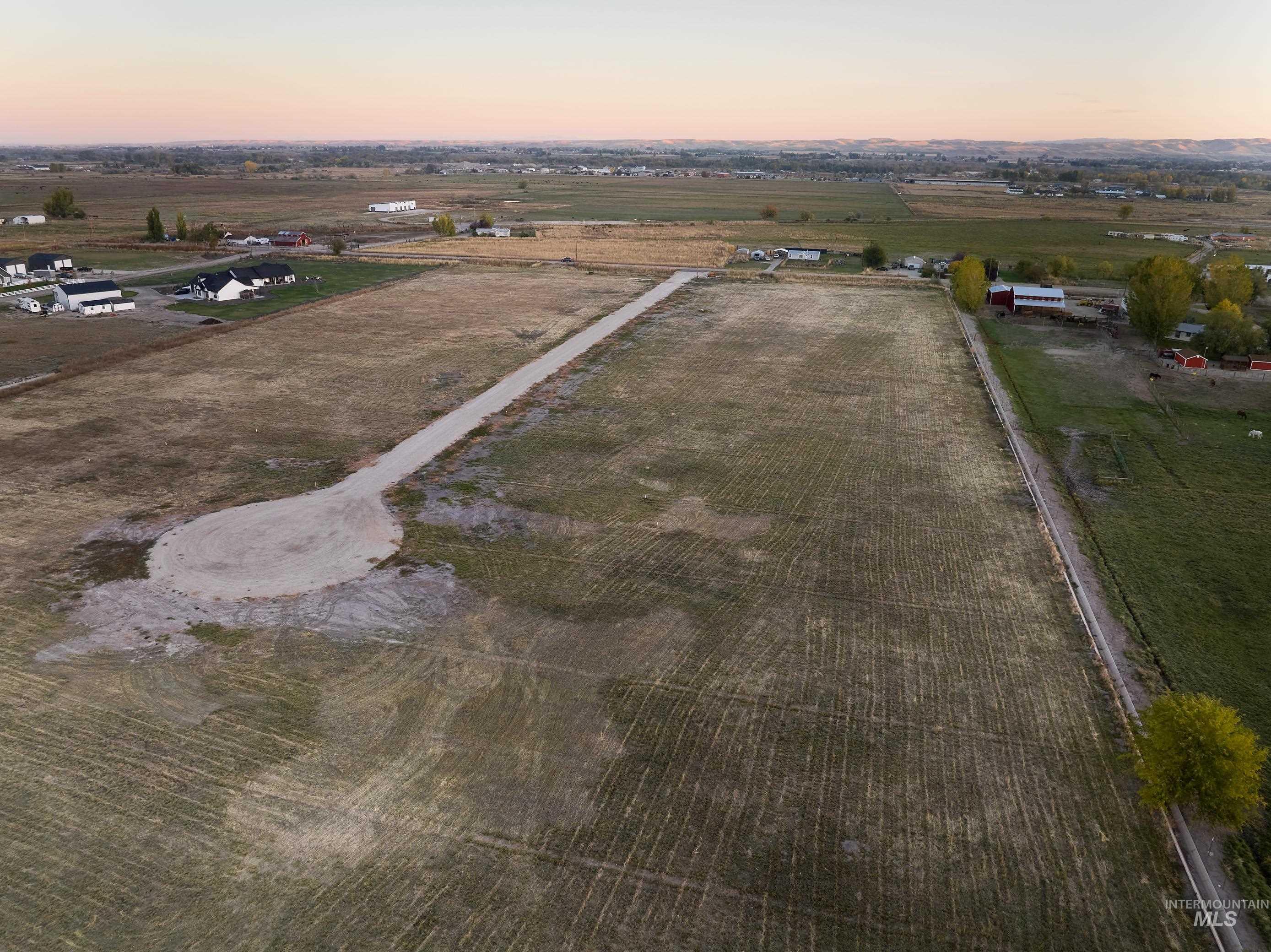 Aerial overview of property's location featuring rural landscape and extensive farmland