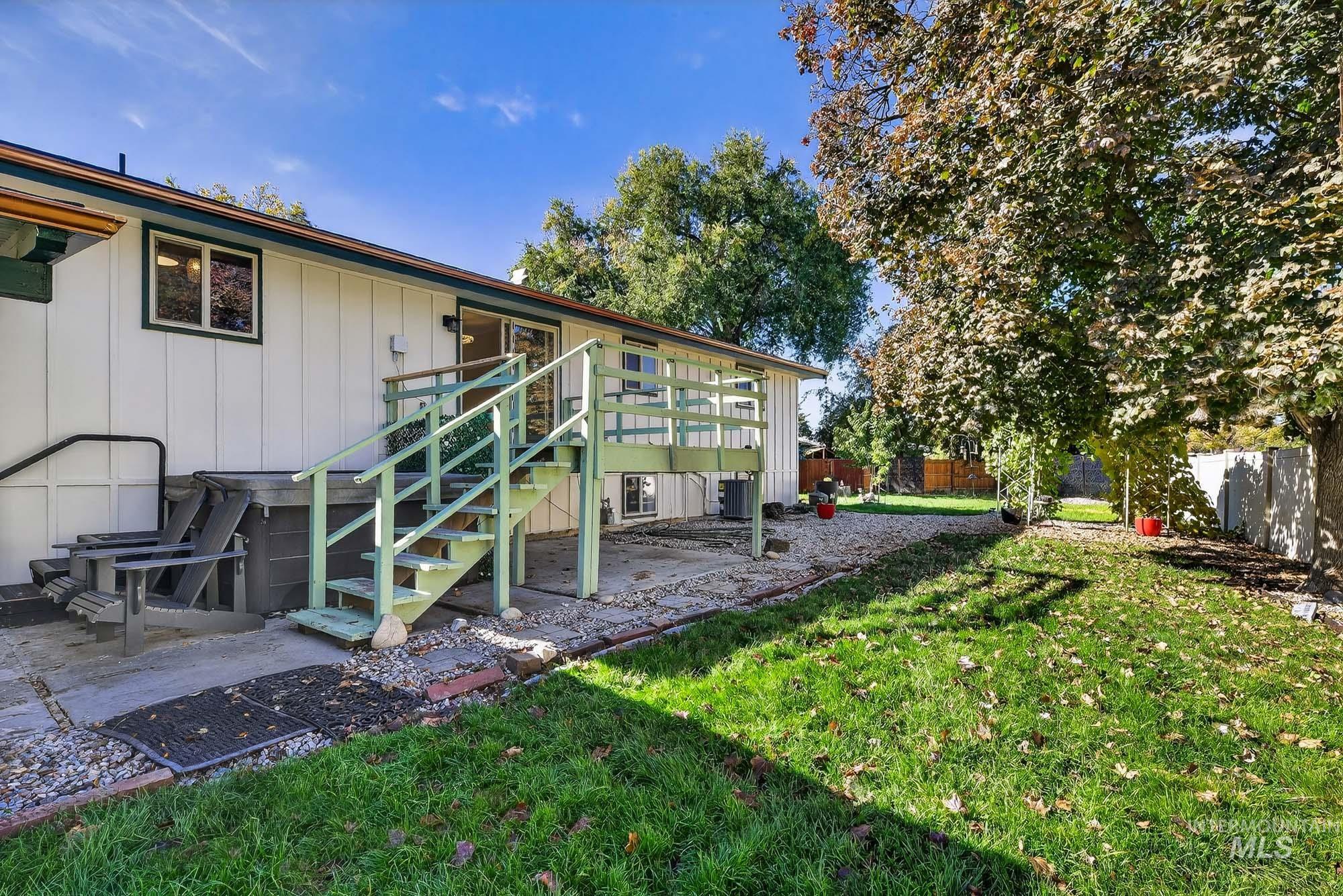 Fenced backyard featuring stairway and a patio area