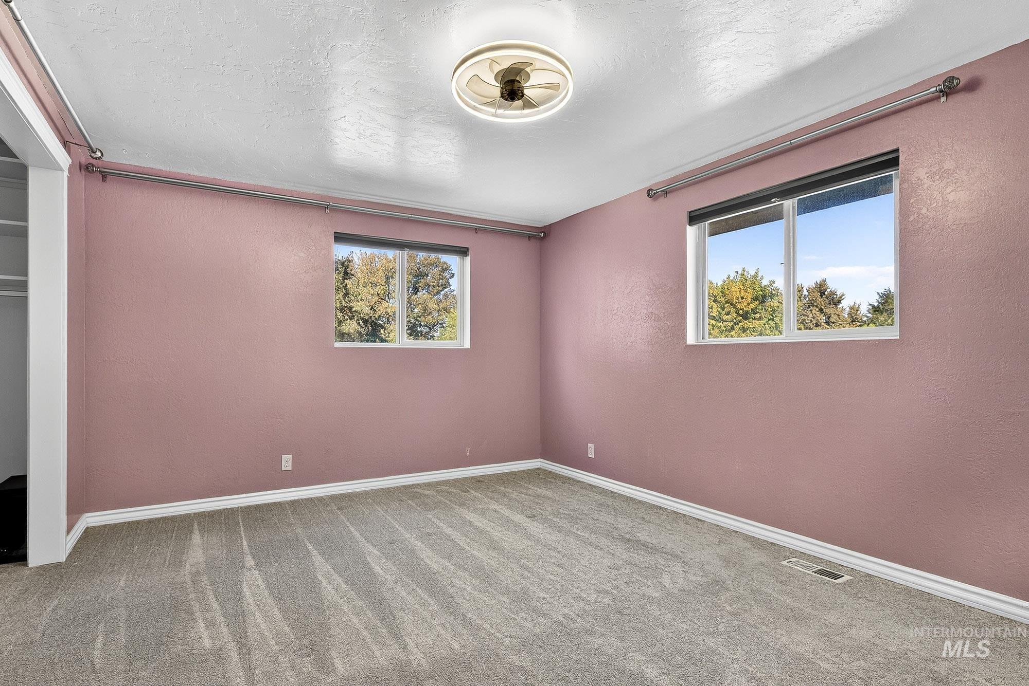 Unfurnished bedroom with carpet and a textured ceiling