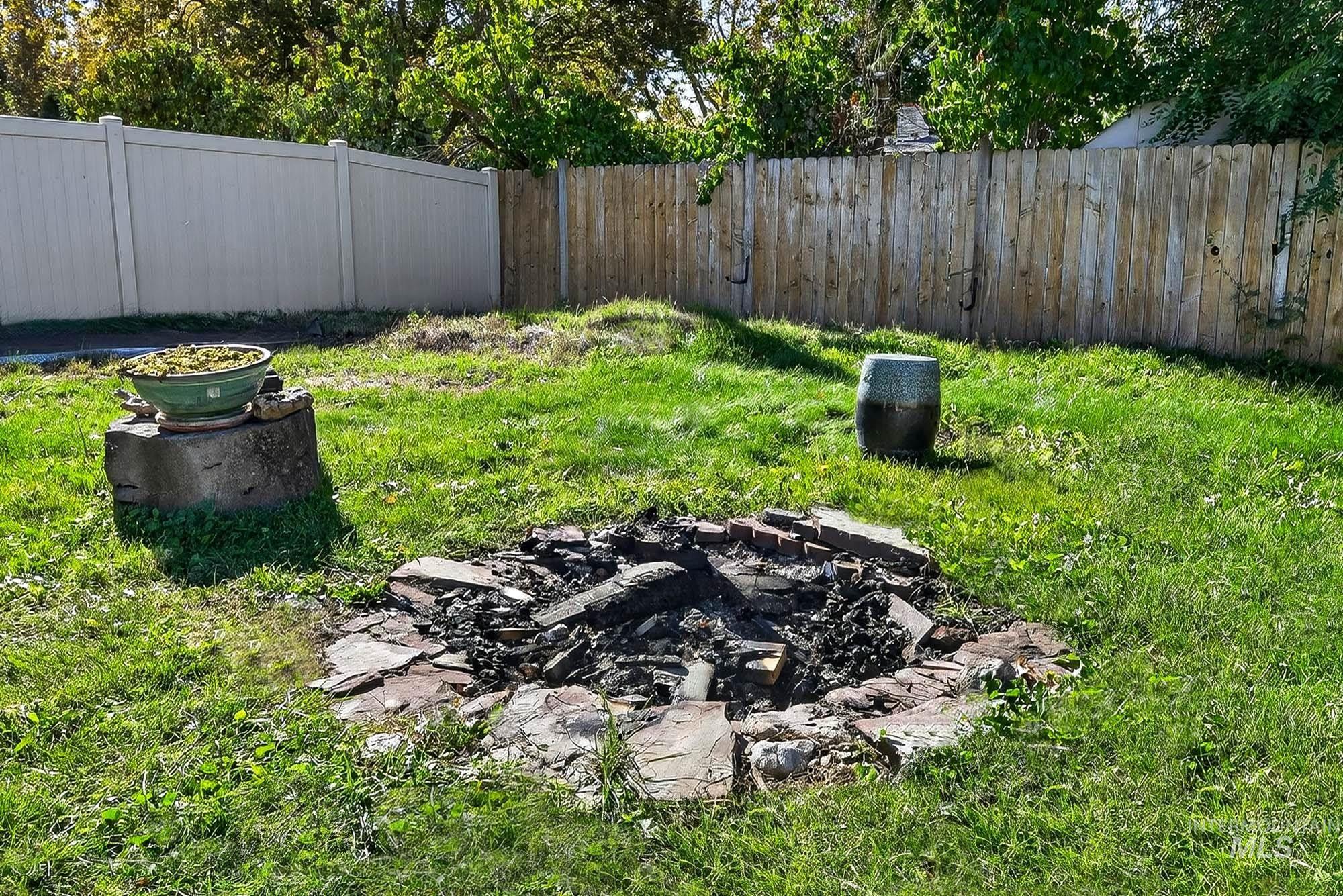 View of yard featuring an outdoor fire pit