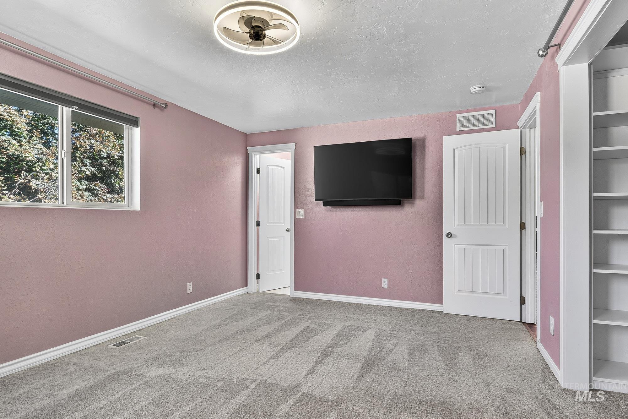 Unfurnished bedroom with carpet floors and a textured ceiling