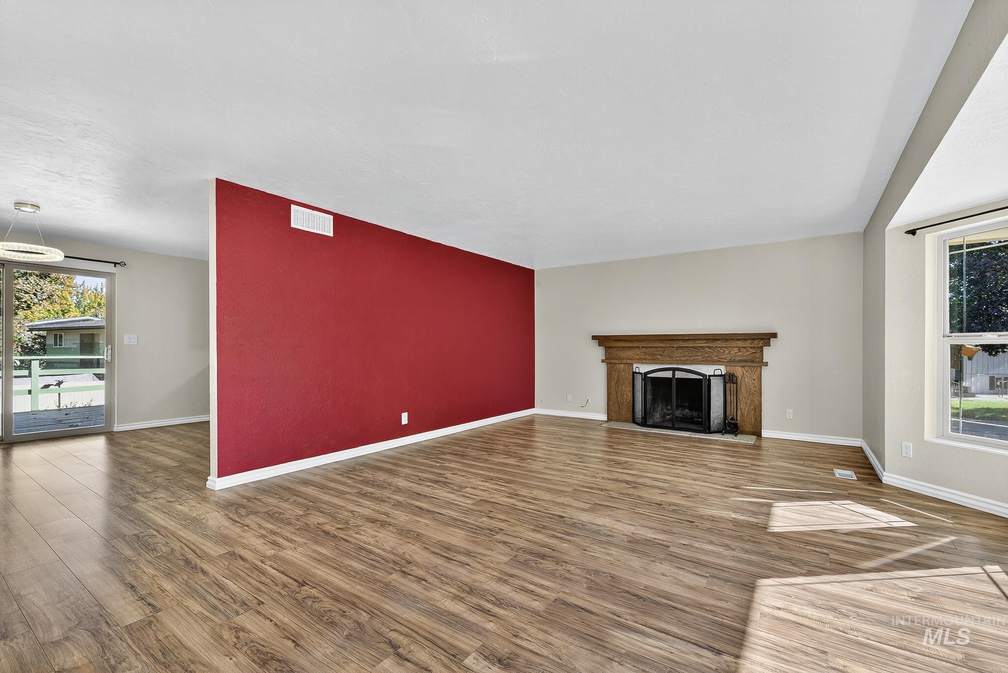 Unfurnished living room featuring wood finished floors and a fireplace