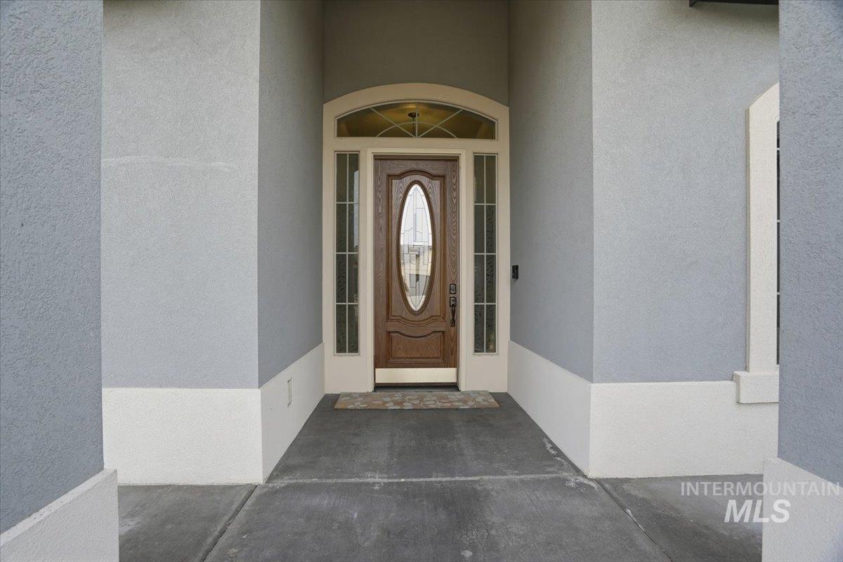 Property entrance featuring stucco siding