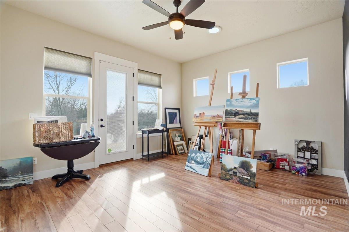 Miscellaneous room with light wood-type flooring and a ceiling fan