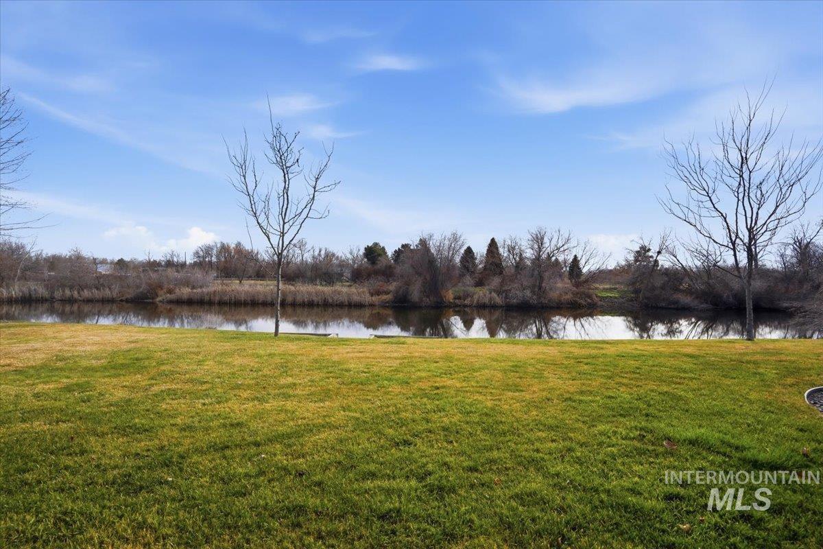 View of grassy yard with a water view