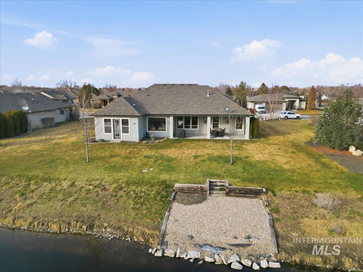 Back of house with a patio, a residential view, and a yard