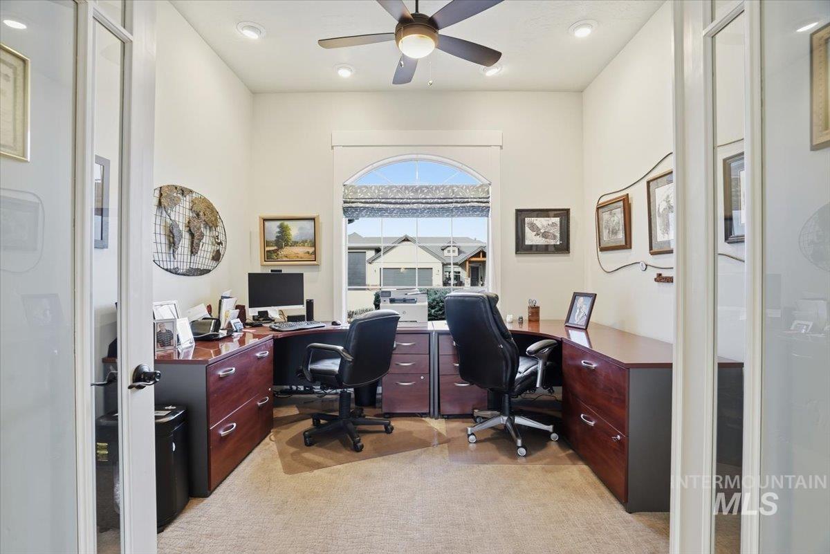 Home office with ceiling fan, light carpet, and recessed lighting