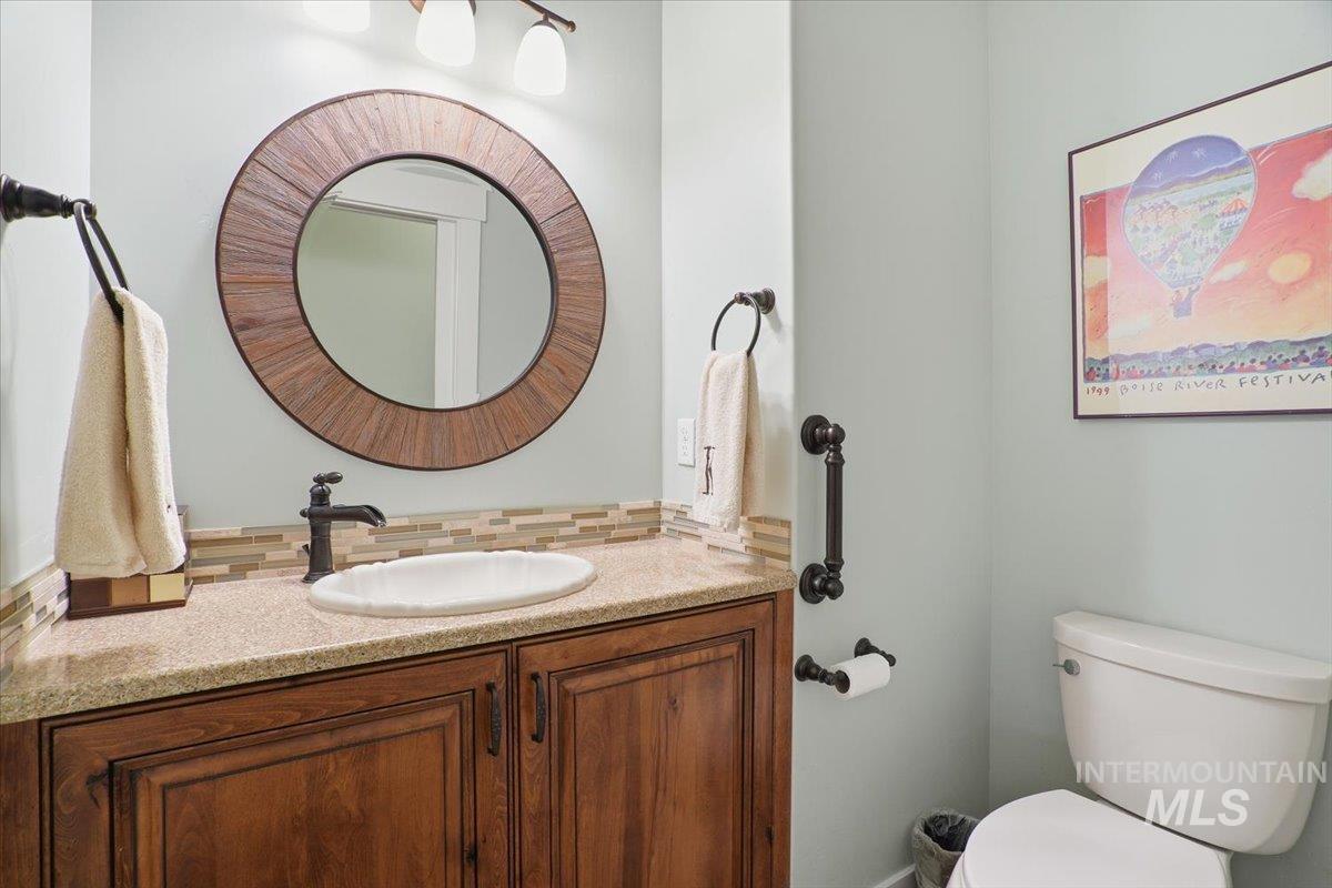 Bathroom with vanity and decorative backsplash