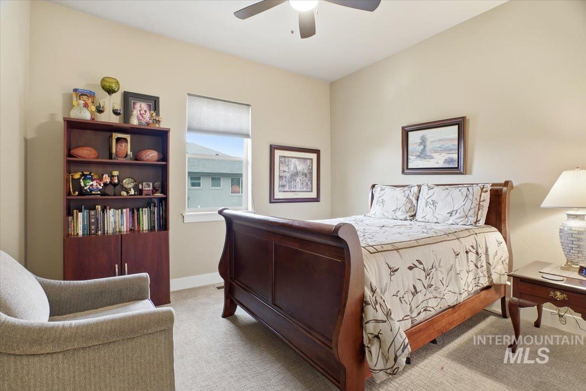 Bedroom featuring light colored carpet and ceiling fan