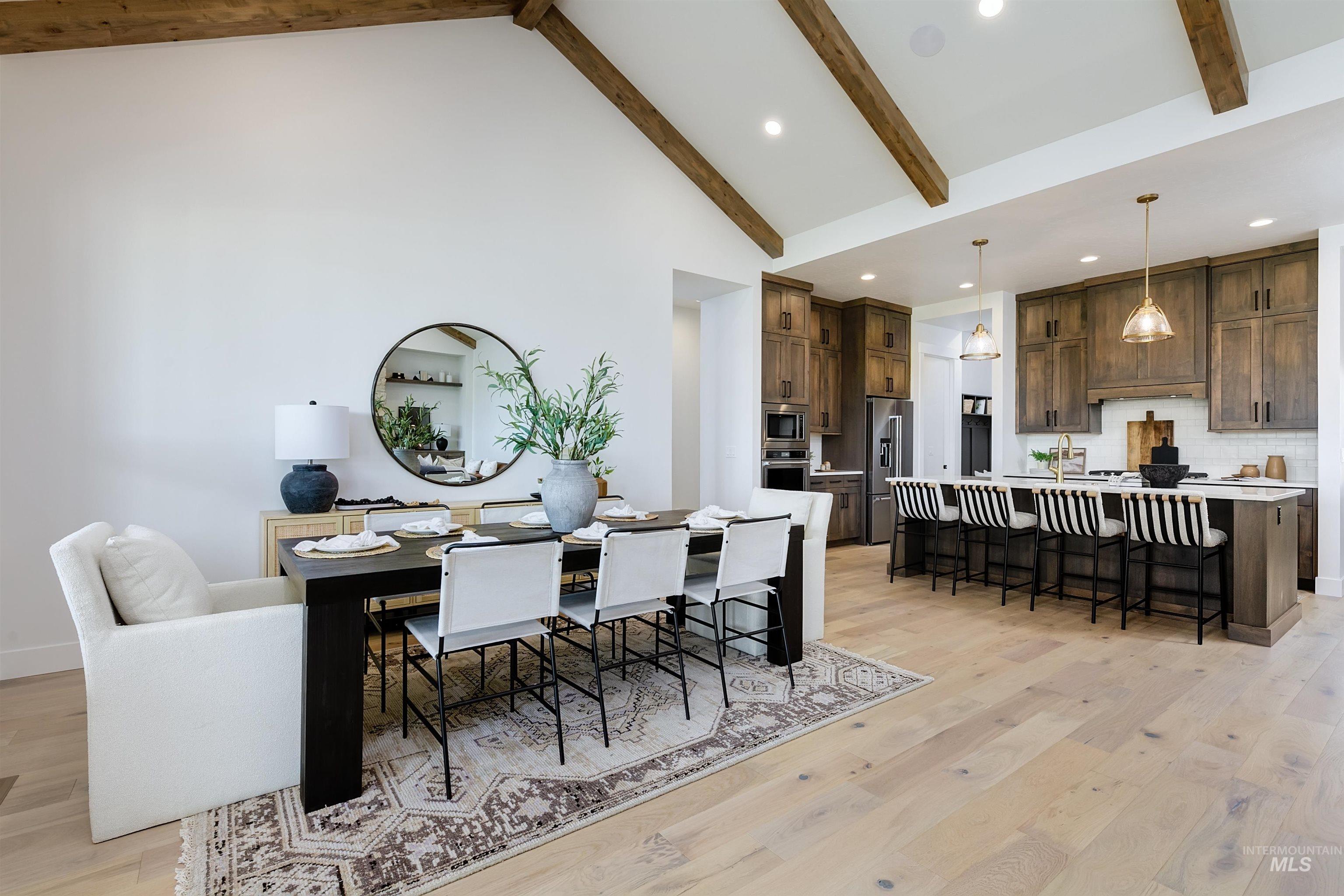 Dining room featuring recessed lighting, light wood-style floors, and vaulted ceiling