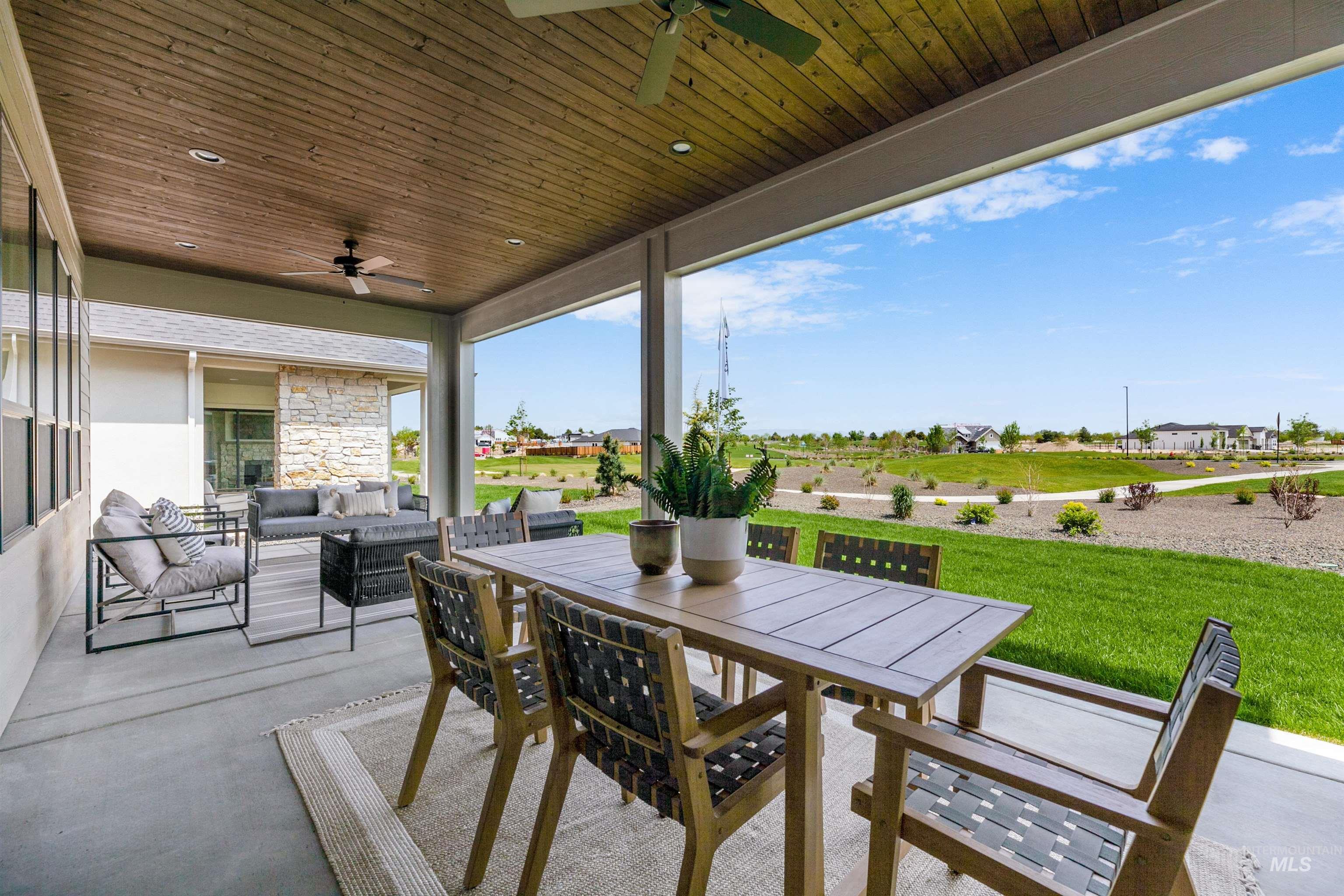 View of patio featuring a ceiling fan, an outdoor living / dining area, and a residential view