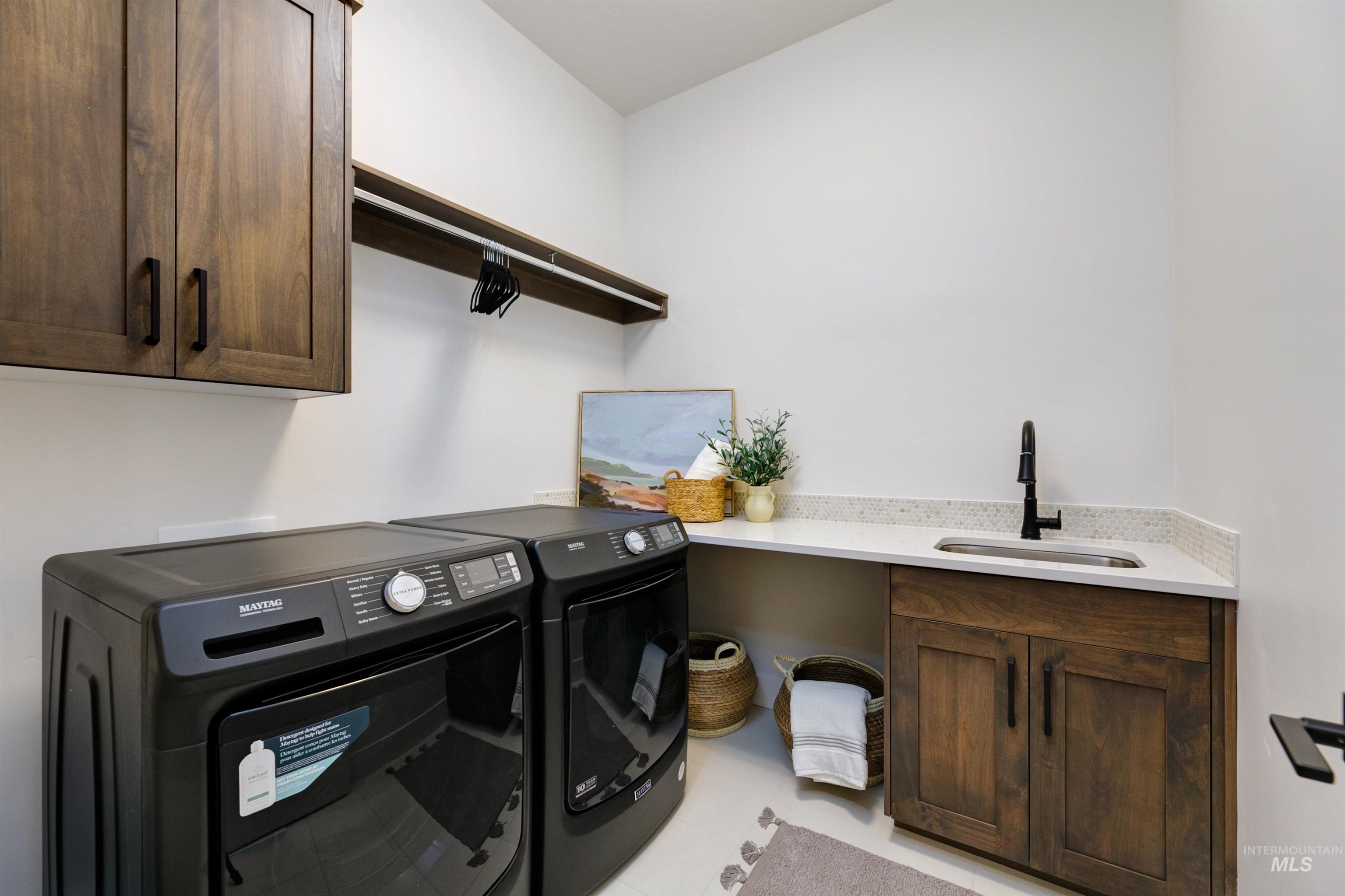 Laundry room featuring cabinet space and separate washer and dryer