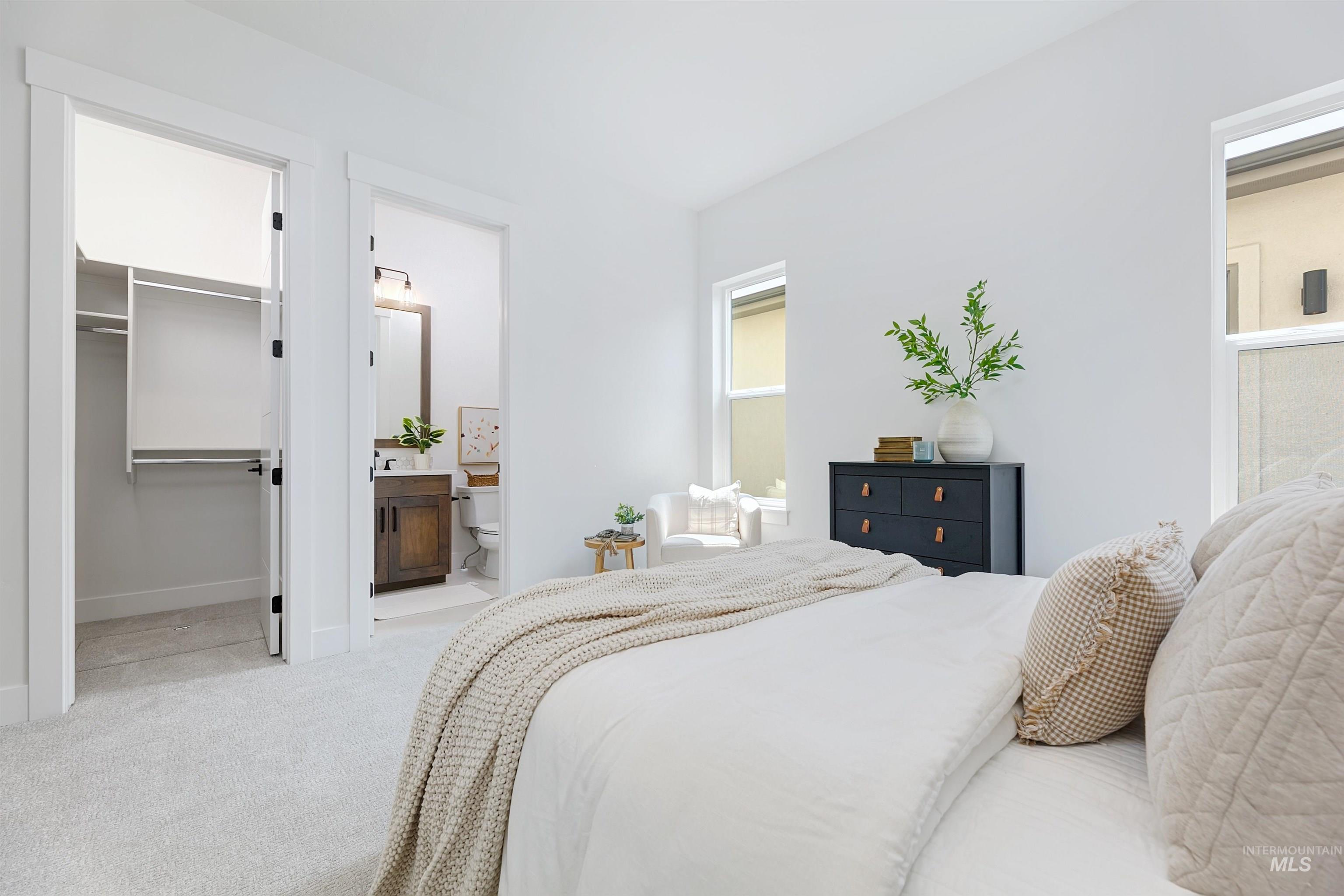 Bedroom featuring a spacious closet and light carpet