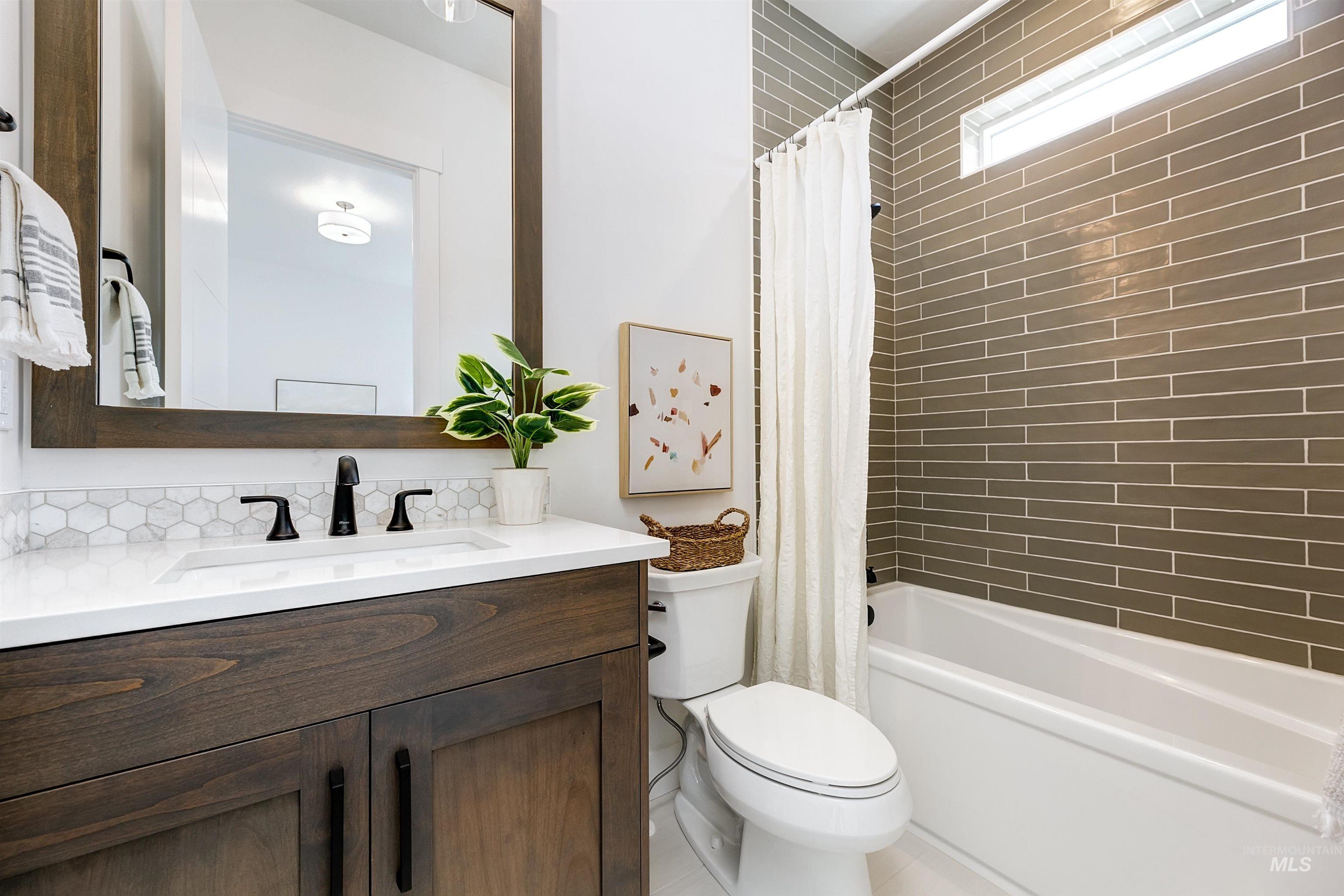 Full bathroom with vanity and shower / bath combo with shower curtain