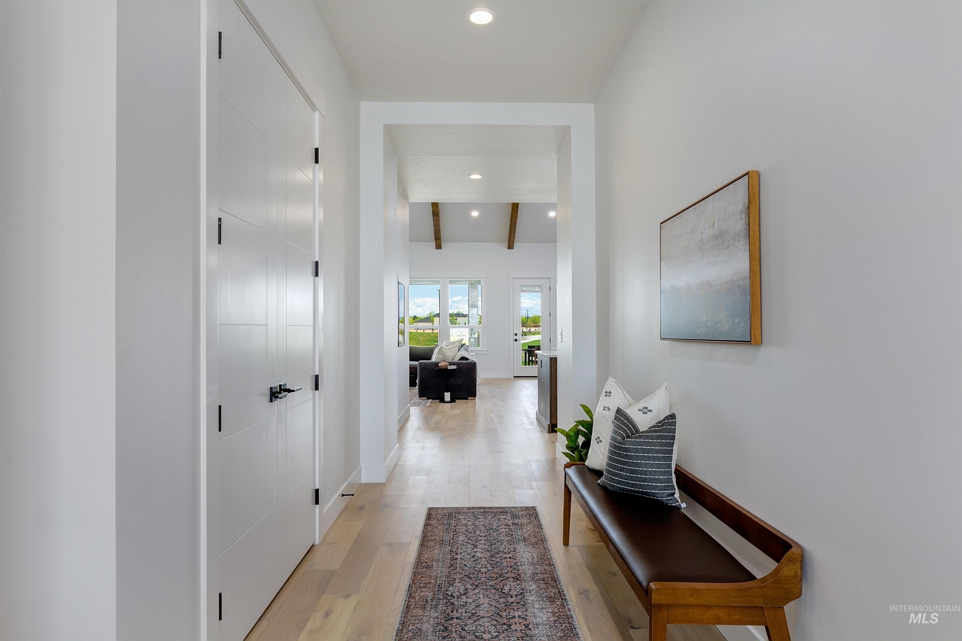 Corridor with light wood-type flooring, recessed lighting, and beamed ceiling