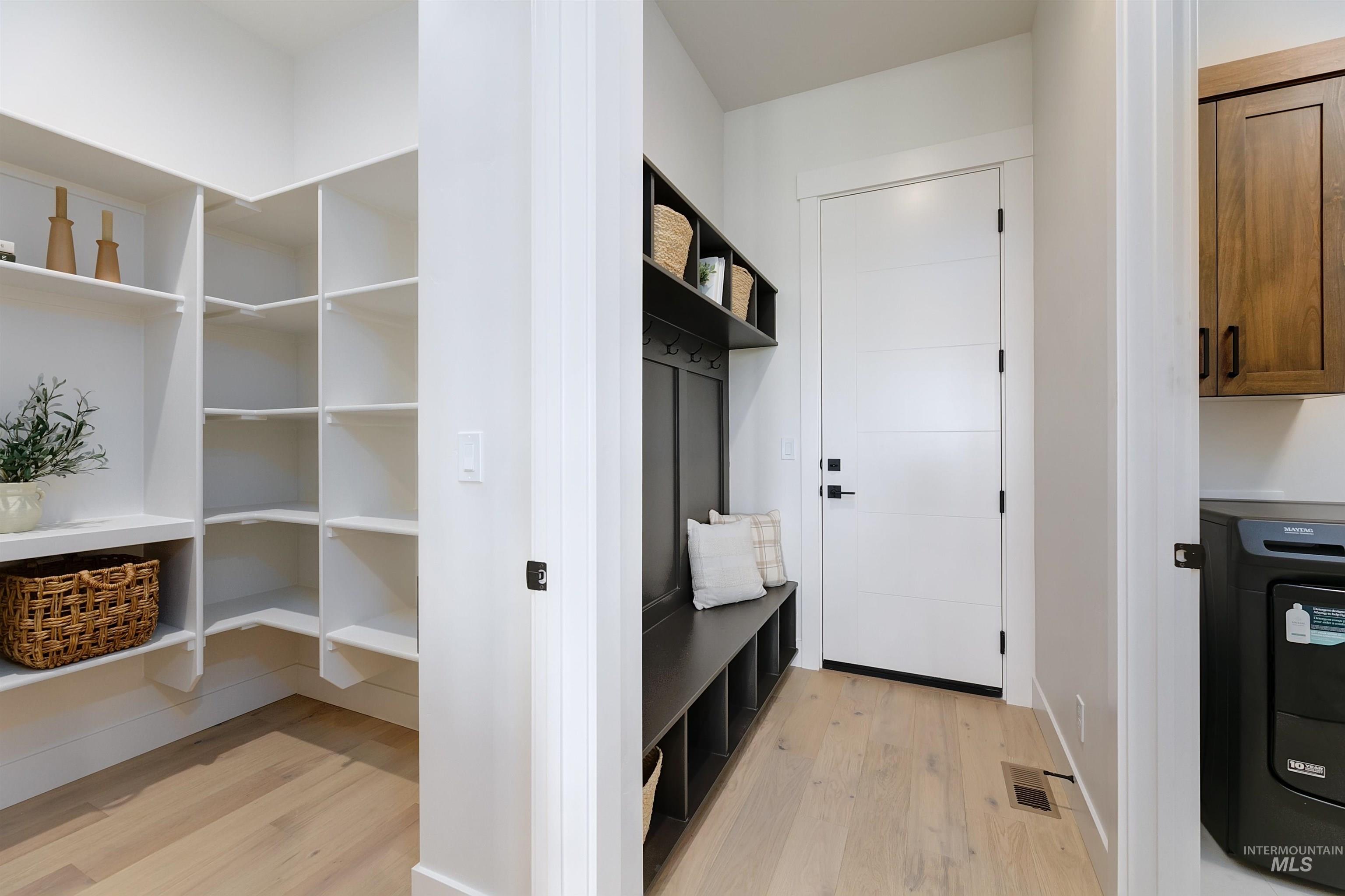 Mudroom with light wood finished floors and washer / clothes dryer