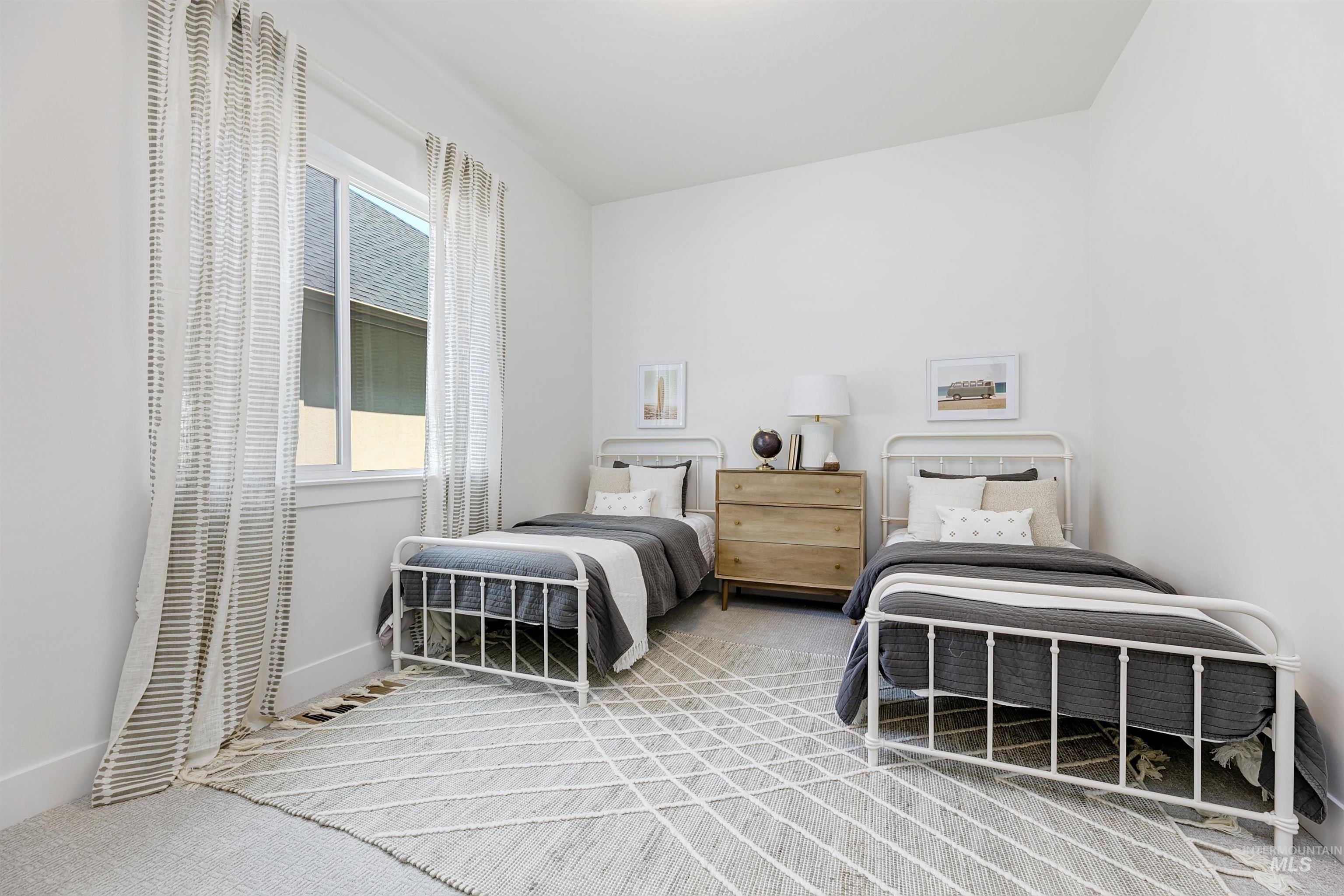 Bedroom with light carpet and baseboards