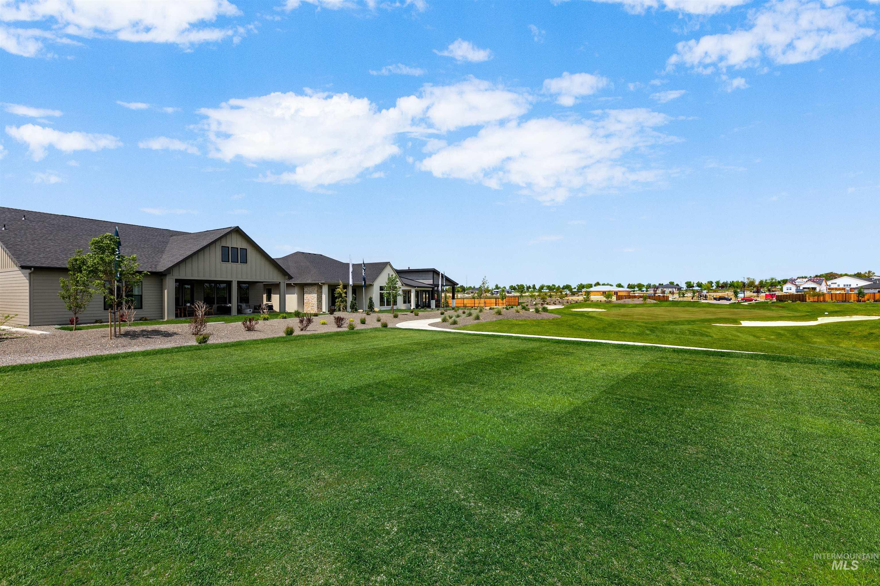 View of grassy yard featuring a residential view and a porch