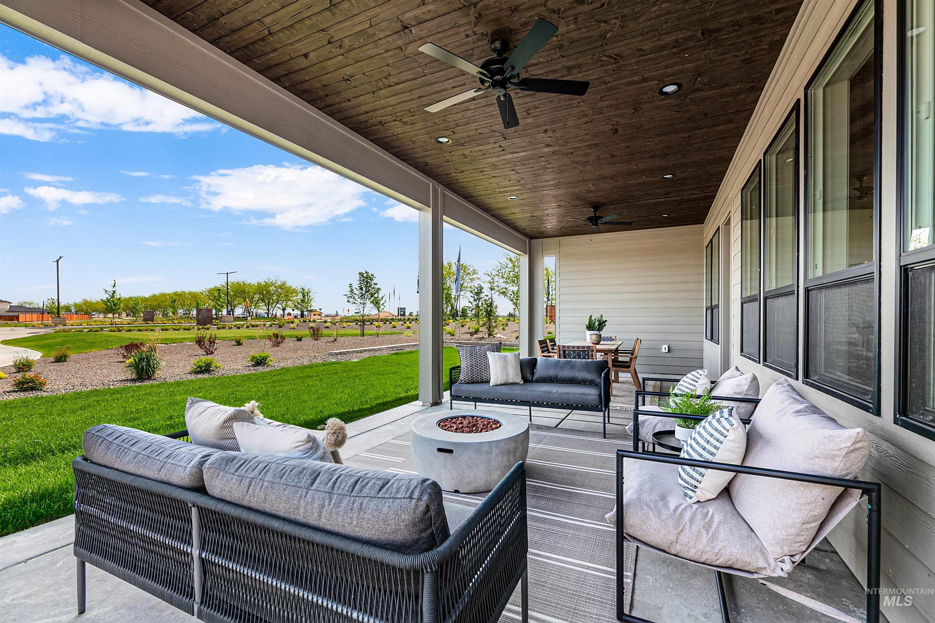 View of patio / terrace with an outdoor living space with a fire pit and a ceiling fan