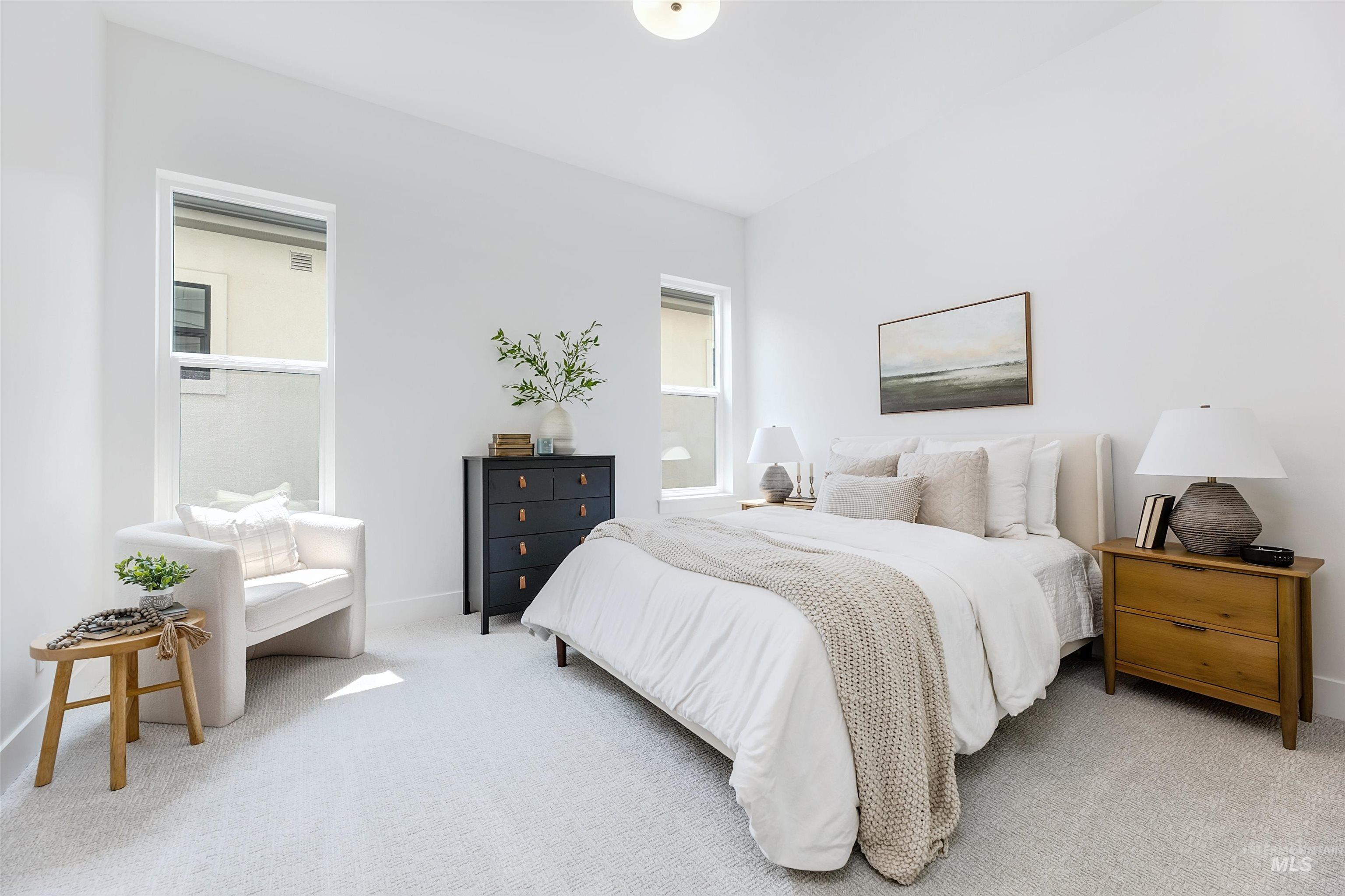 Bedroom featuring light carpet and baseboards