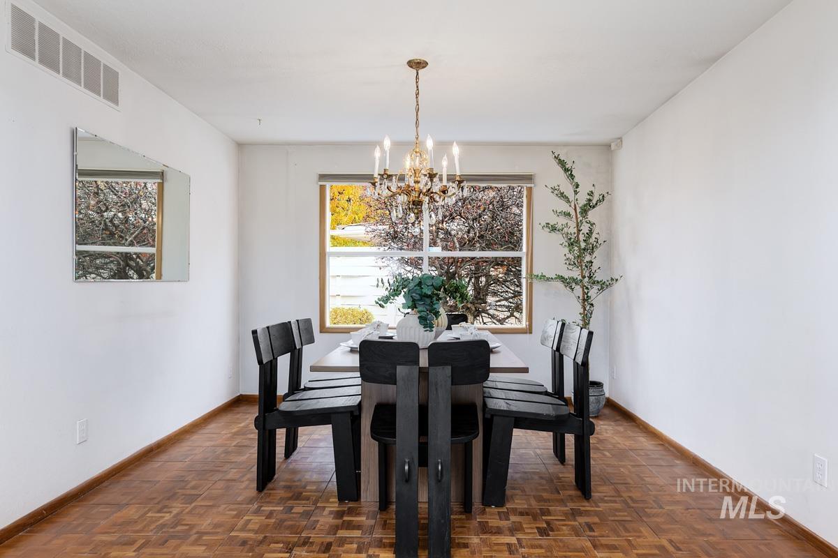 Dining space with baseboards and a chandelier