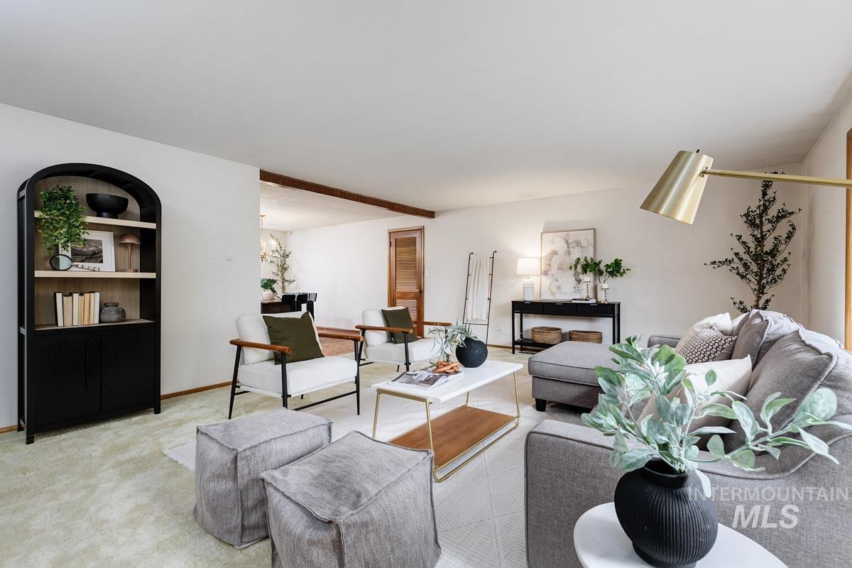 Carpeted living room with baseboards