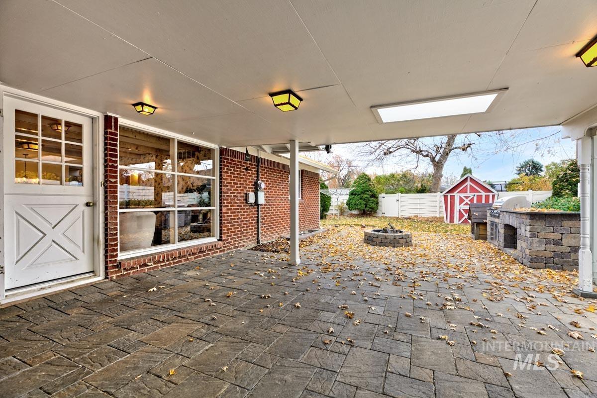 View of patio featuring grilling area and a fire pit
